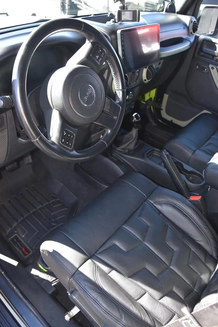 The interior of a car with black leather seats and a steering wheel