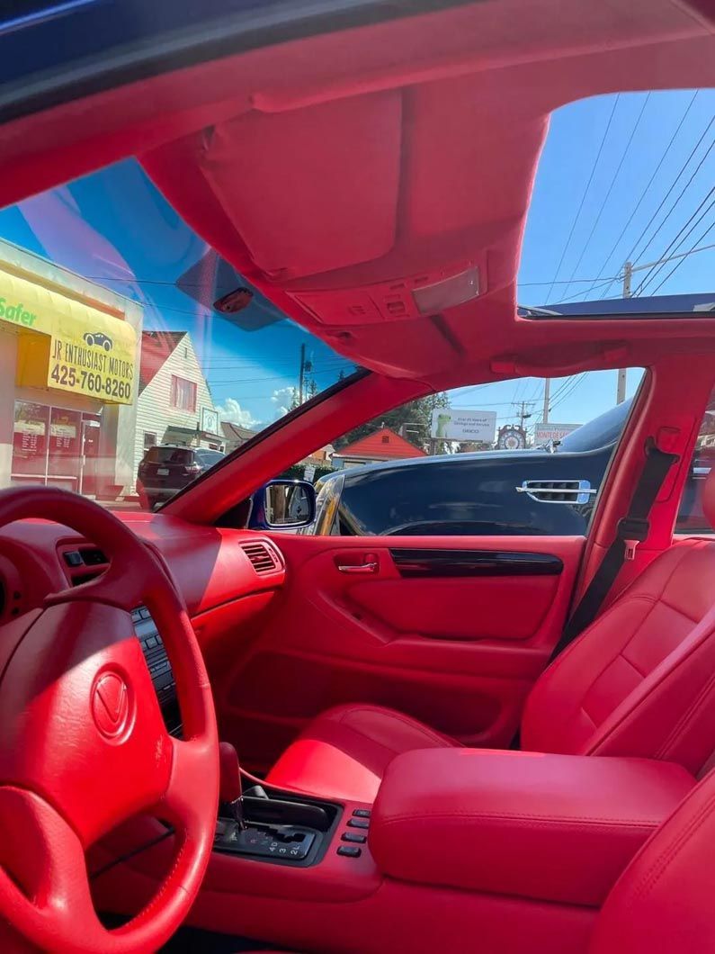 The inside of a red car with a sunroof