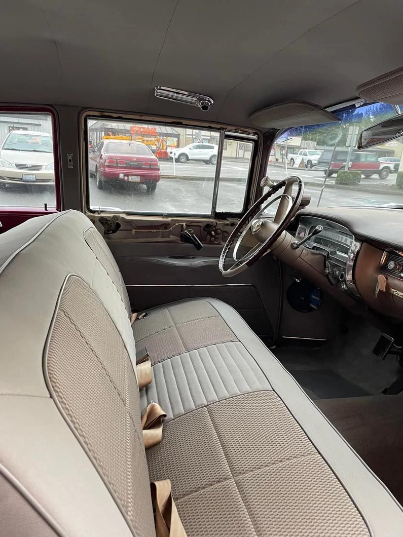 A close up of the interior of a car with a steering wheel.
