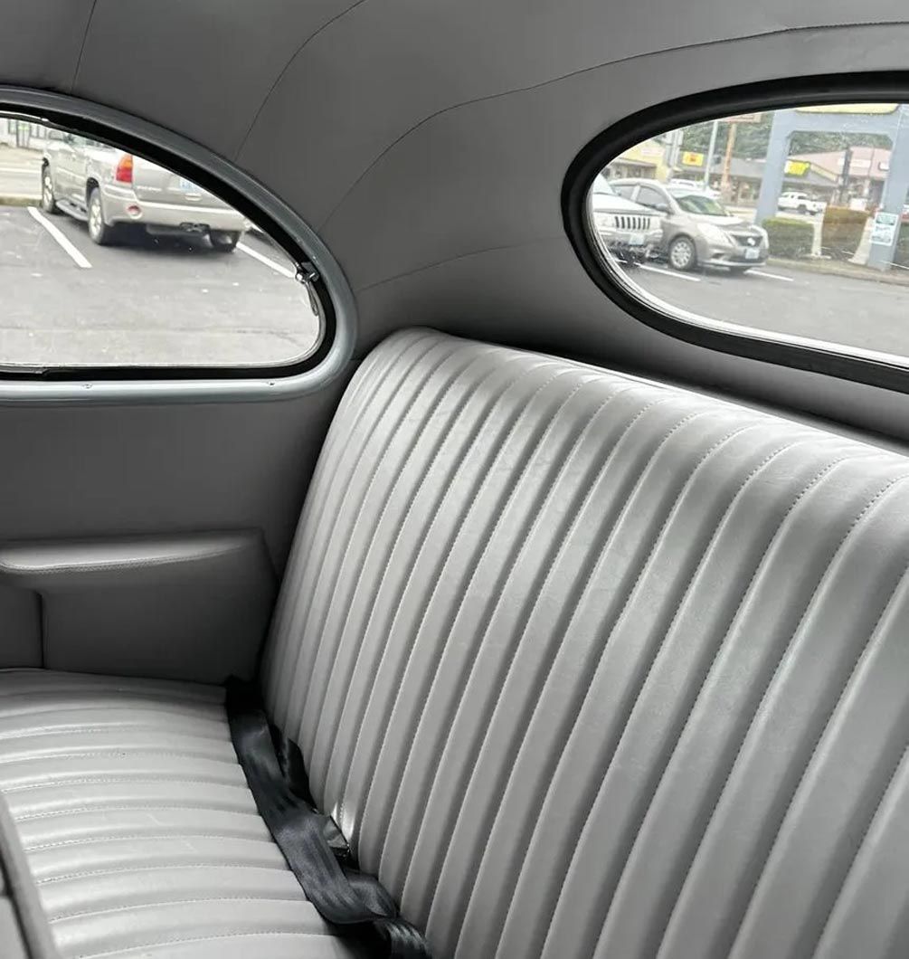 The back seat of a car with a view of a parking lot
