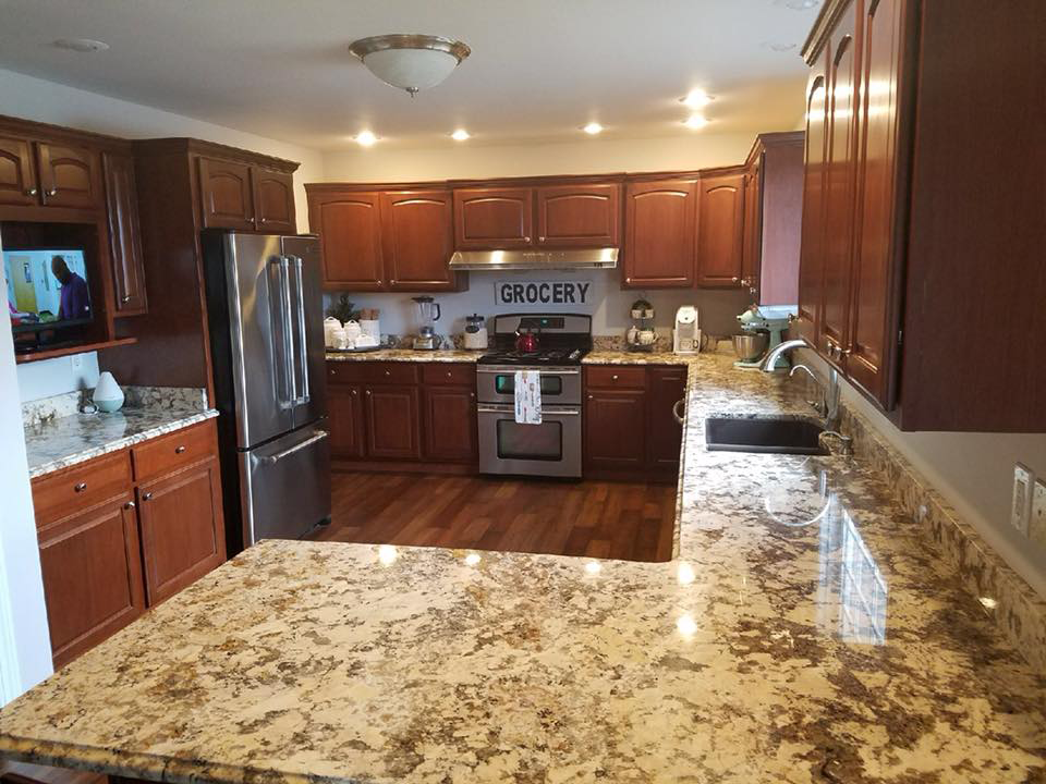 a kitchen with stainless steel appliances and granite counter tops