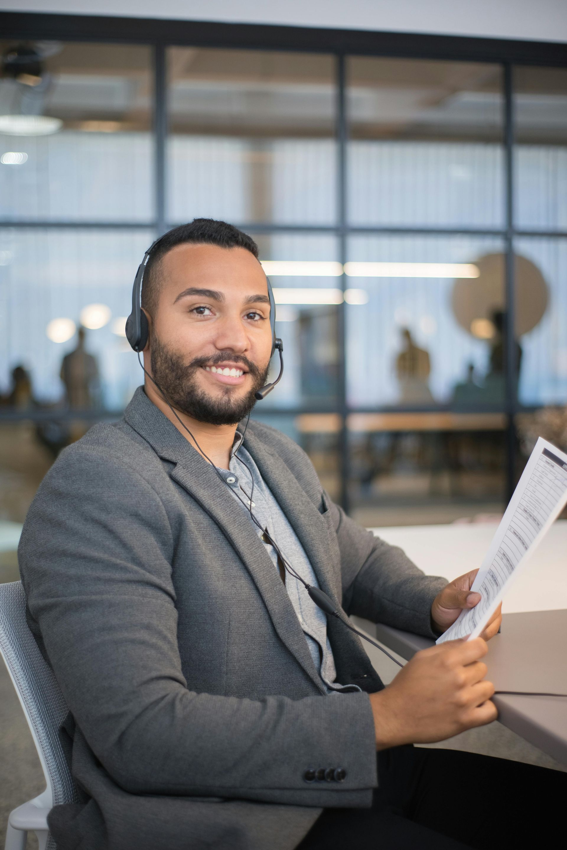 A woman is sitting at a table using a laptop computer.