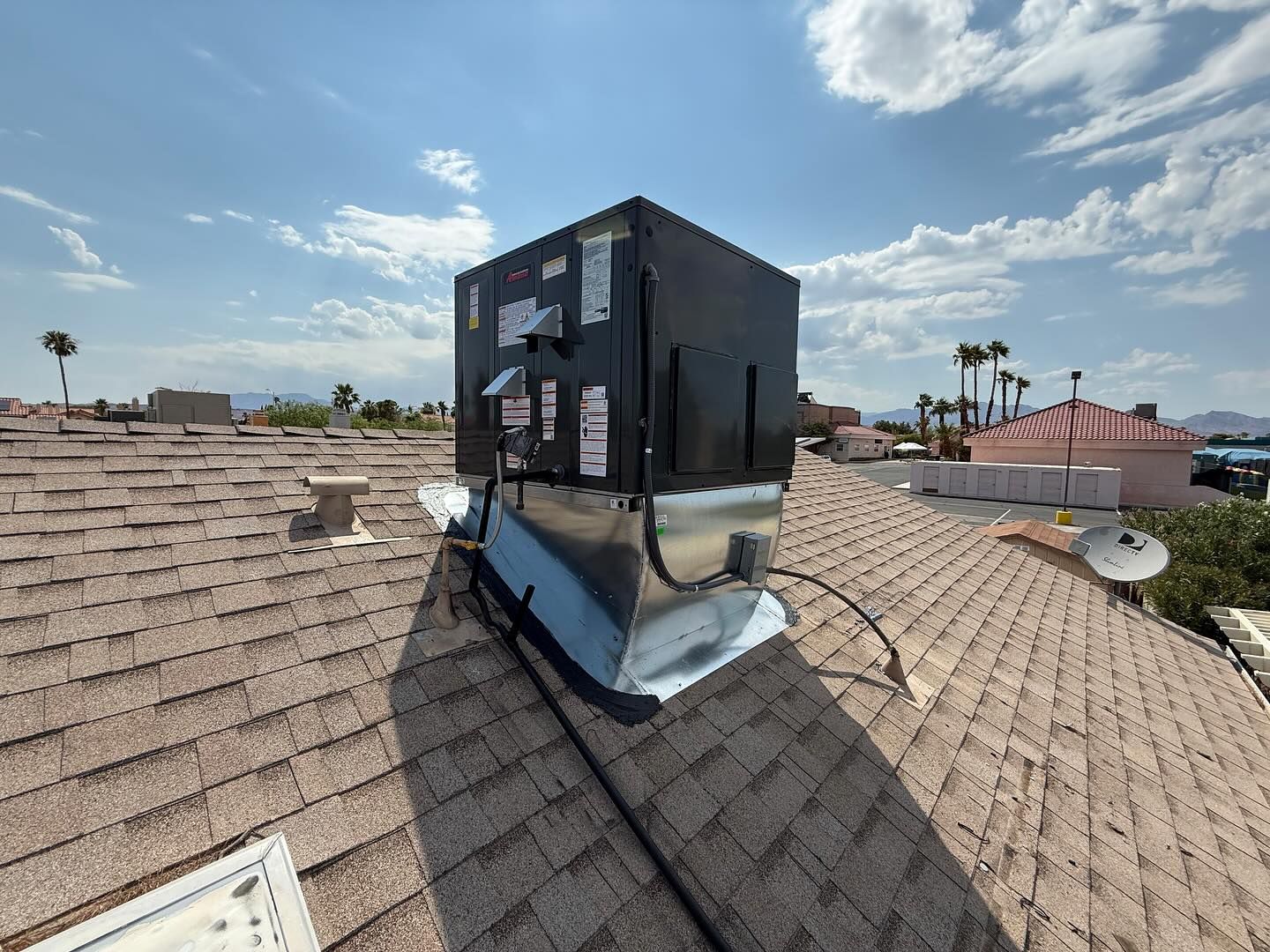 A large black box is sitting on top of a roof.