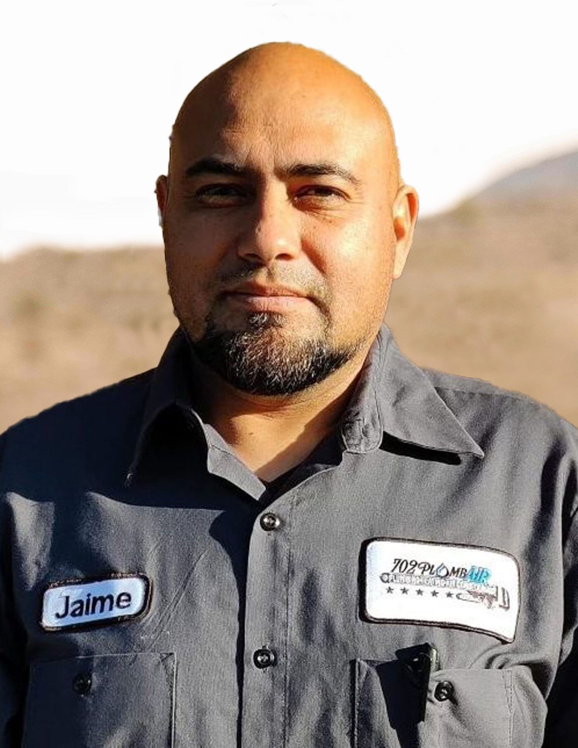 A bald man with a beard and a name tag that says jaime