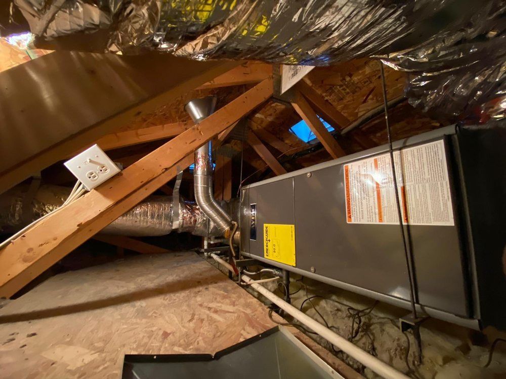 An air conditioner is installed in the attic of a house.