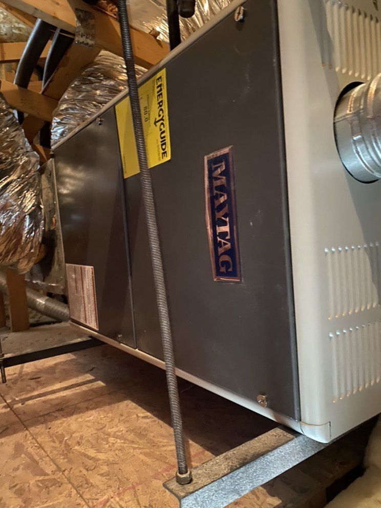 A maytag air conditioner is hanging from the ceiling