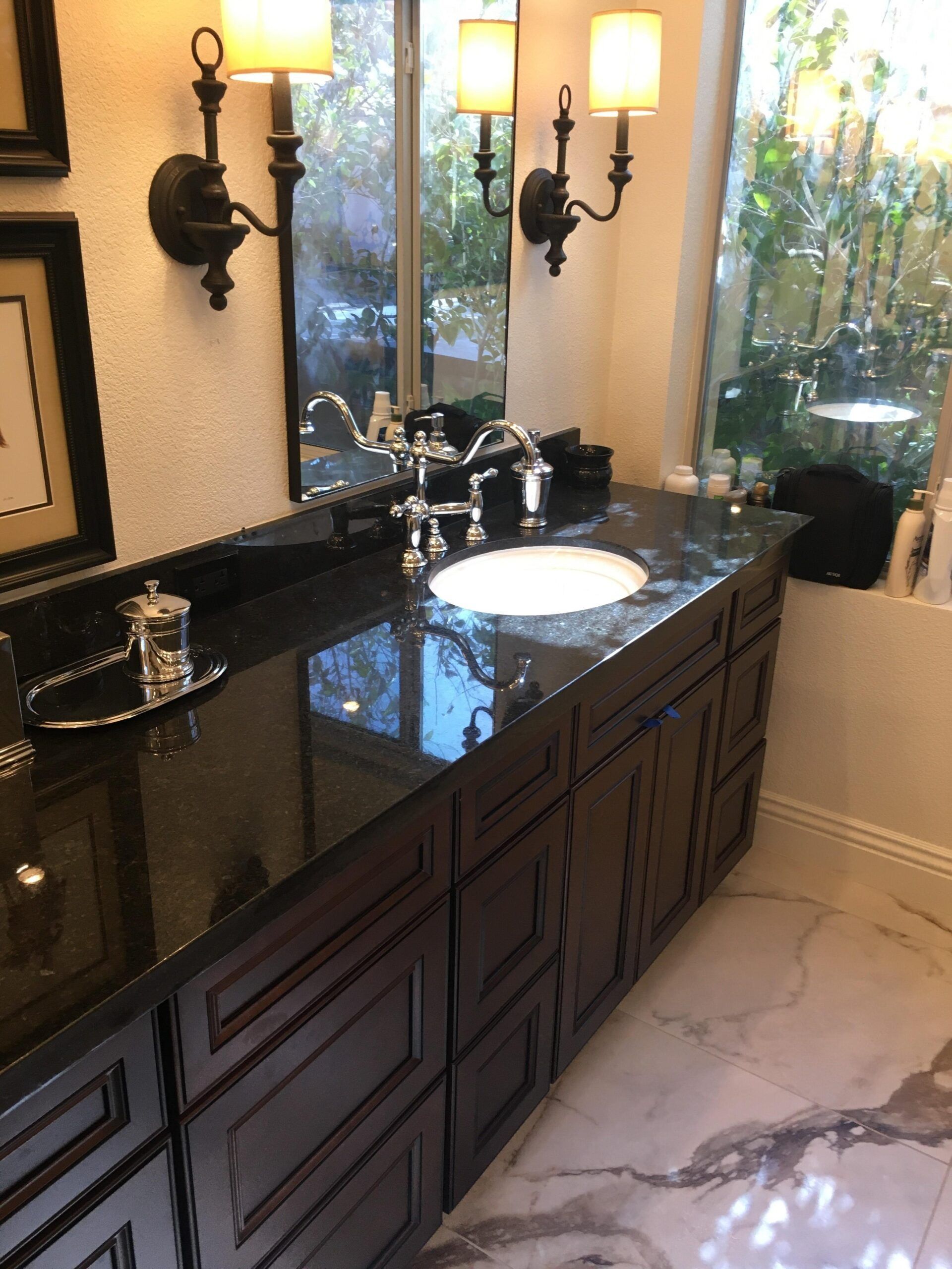 A bathroom with black cabinets and a sink