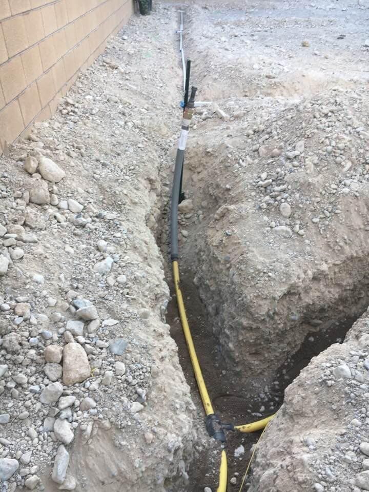 A hole in the ground with a yellow pipe in it