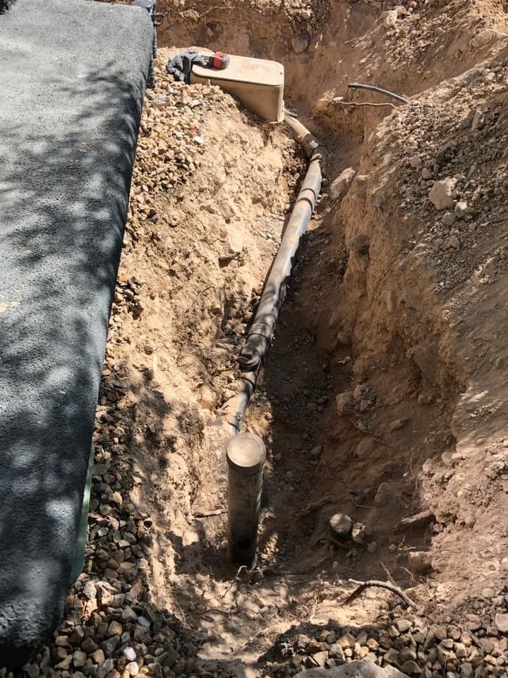 A pipe is coming out of a hole in the ground.