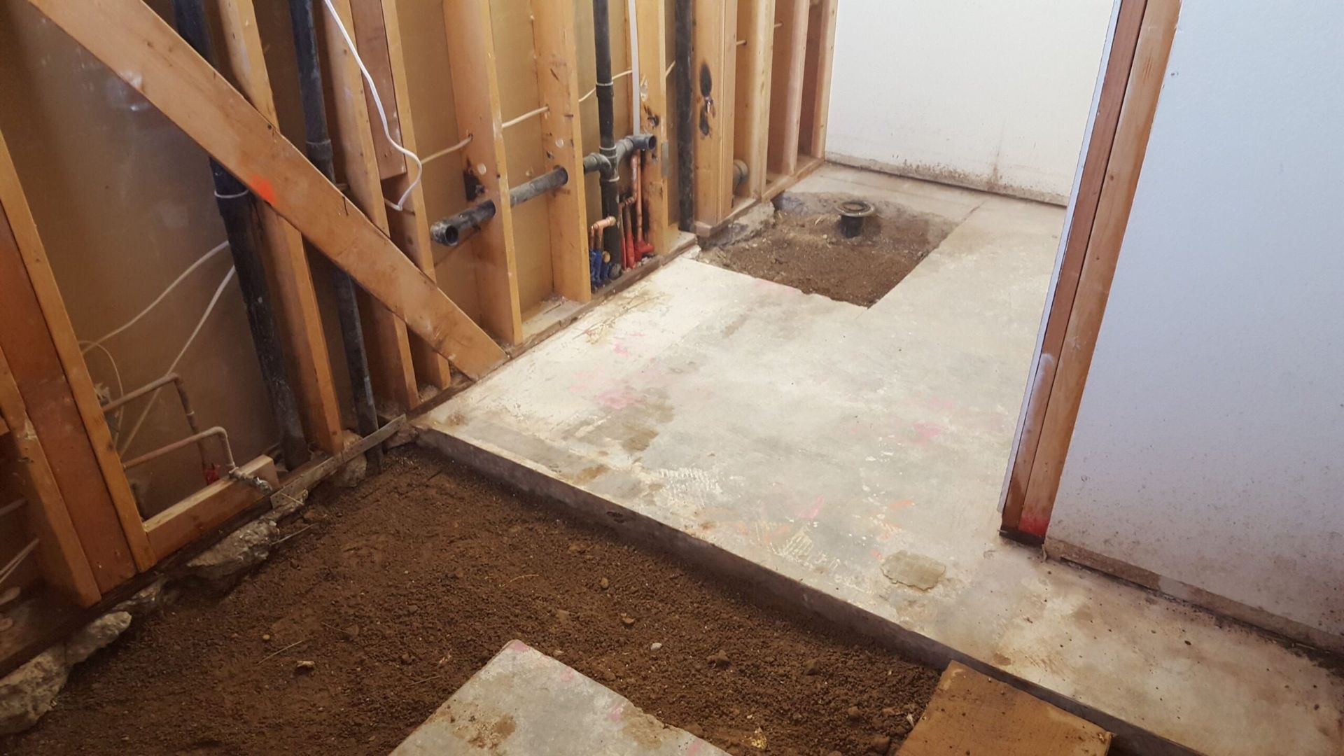 A bathroom under construction with a hole in the floor.