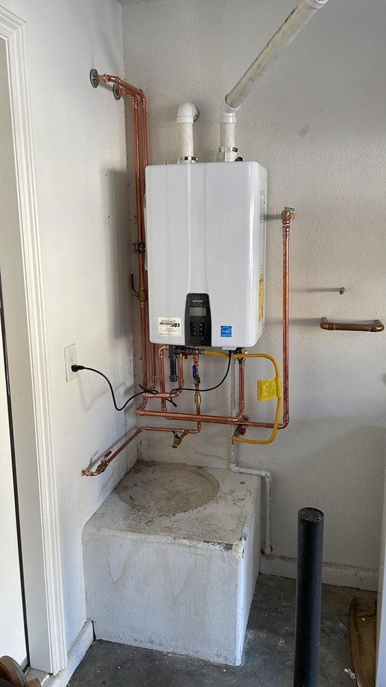 A water heater is installed in a room next to a wall.
