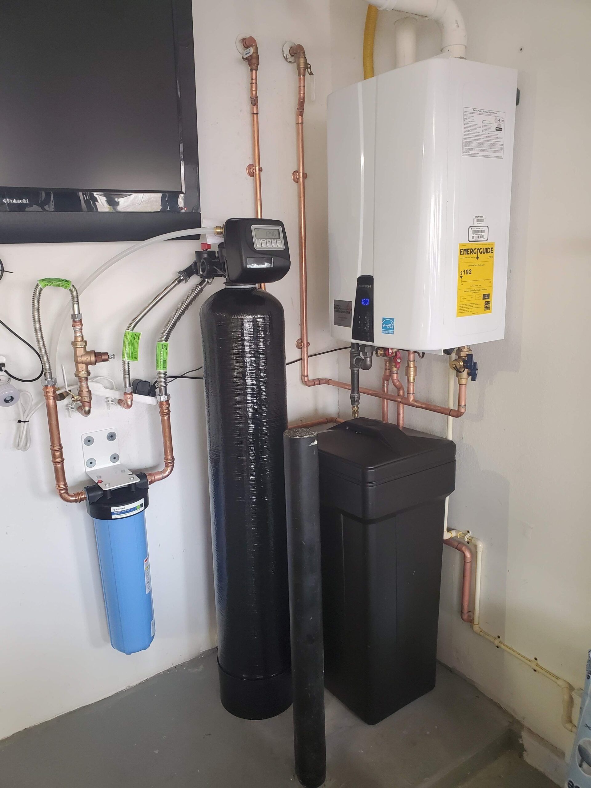 A room with a water filter and a water heater