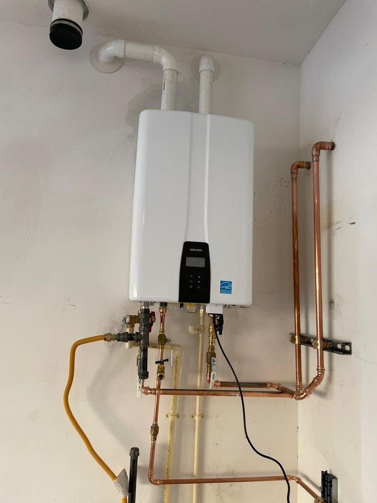 A white water heater with copper pipes attached to it