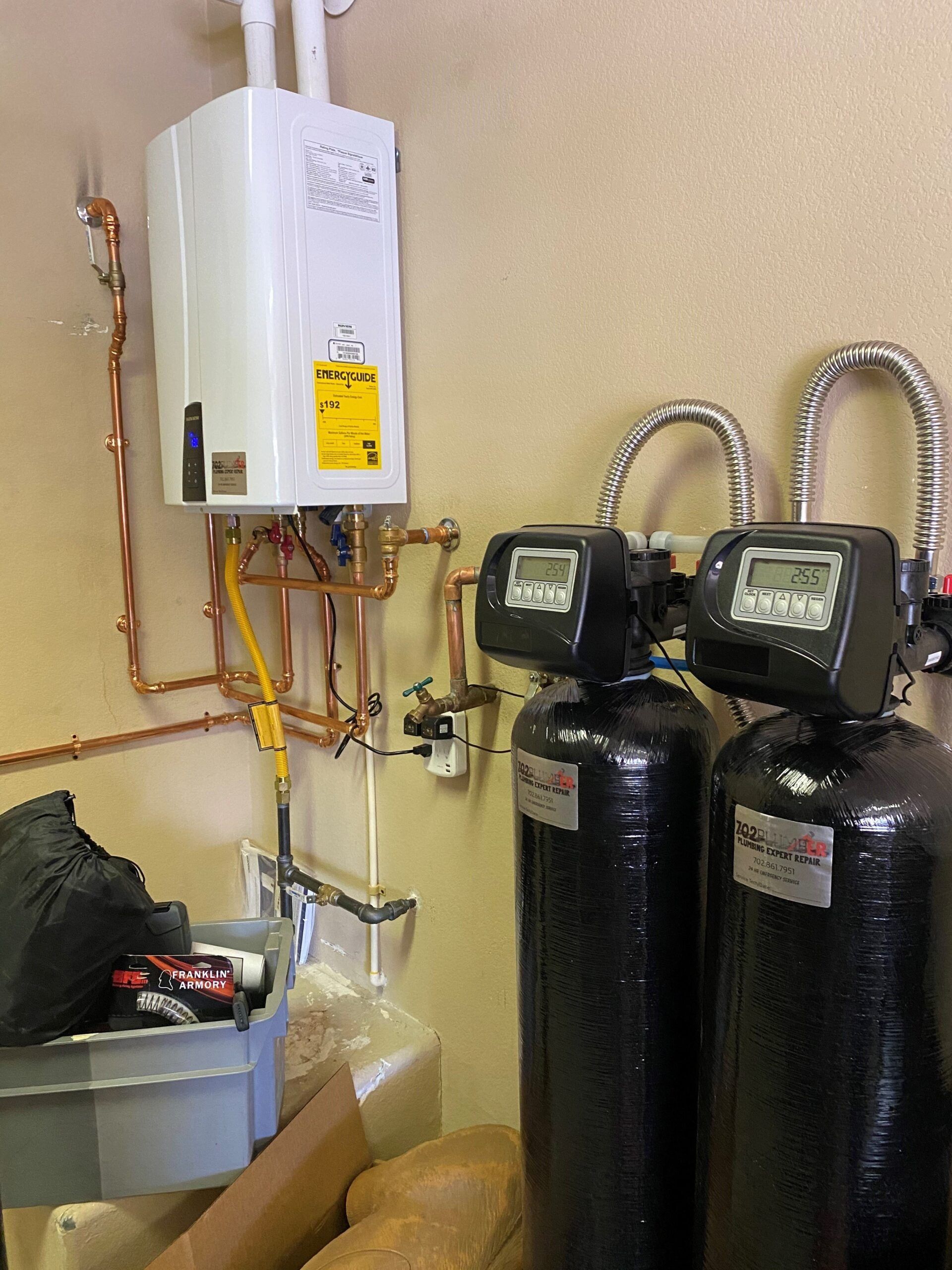 A room with a water heater and two water filters.