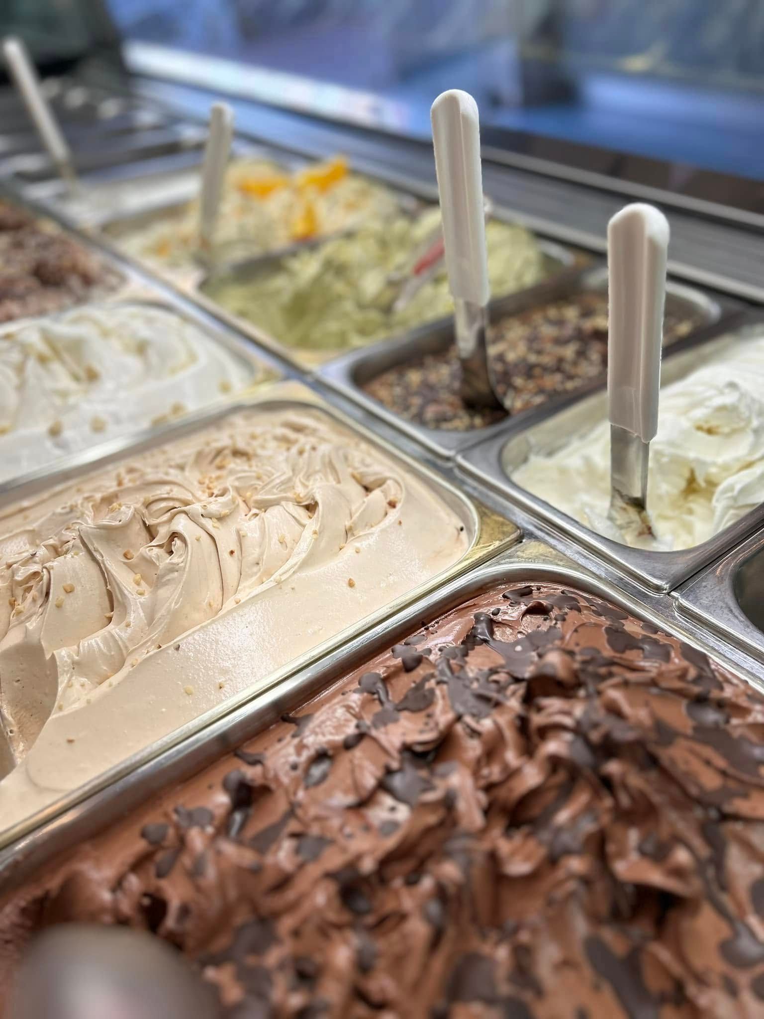 Ci sono molti gusti diversi di gelato nelle vaschette.