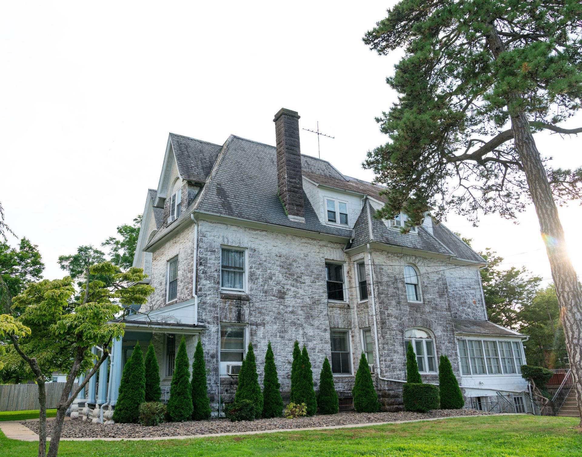 Photo of the side and back of a multi-story building showing the old architectural style of the building