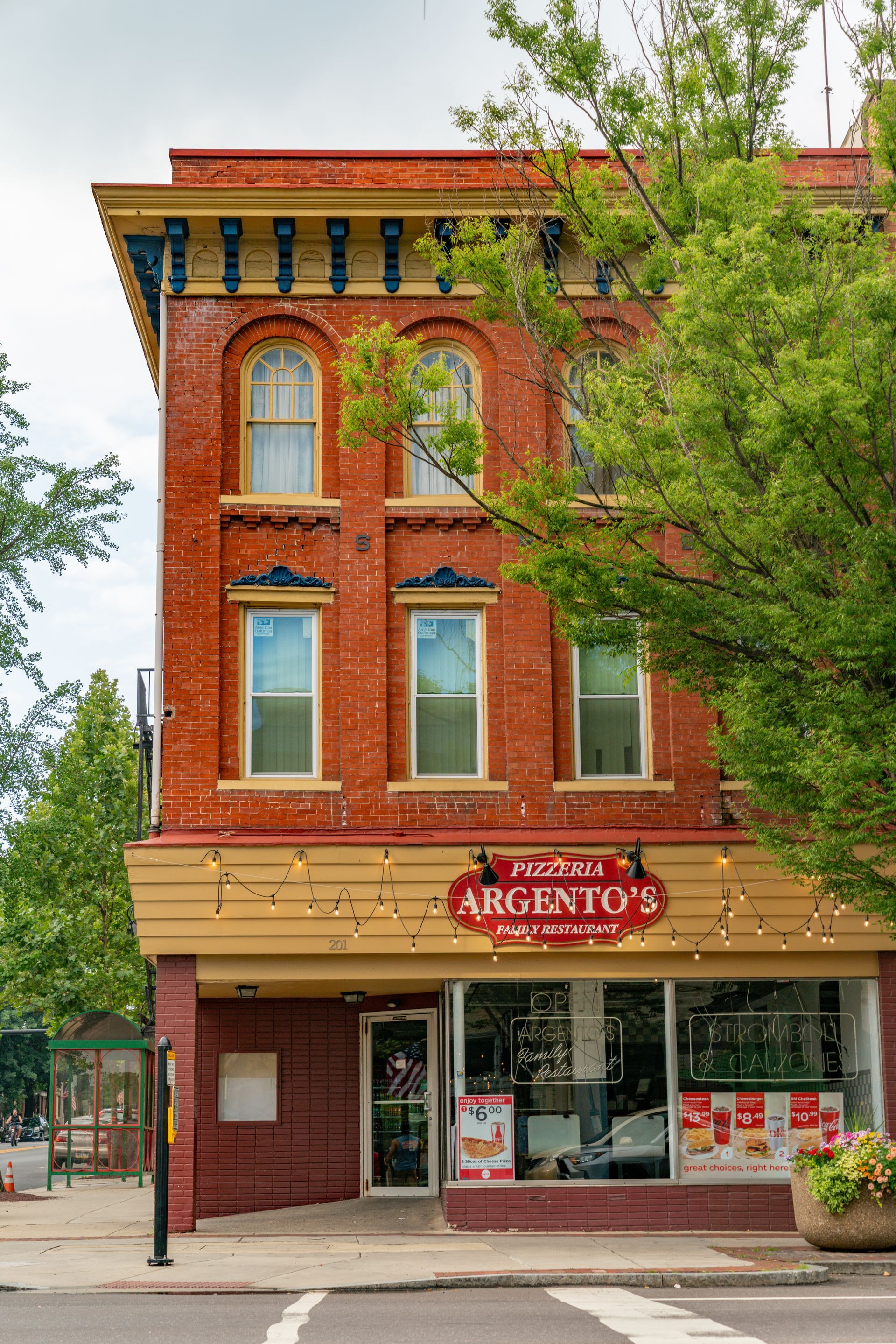Photo of the front of a 3 story red brick building