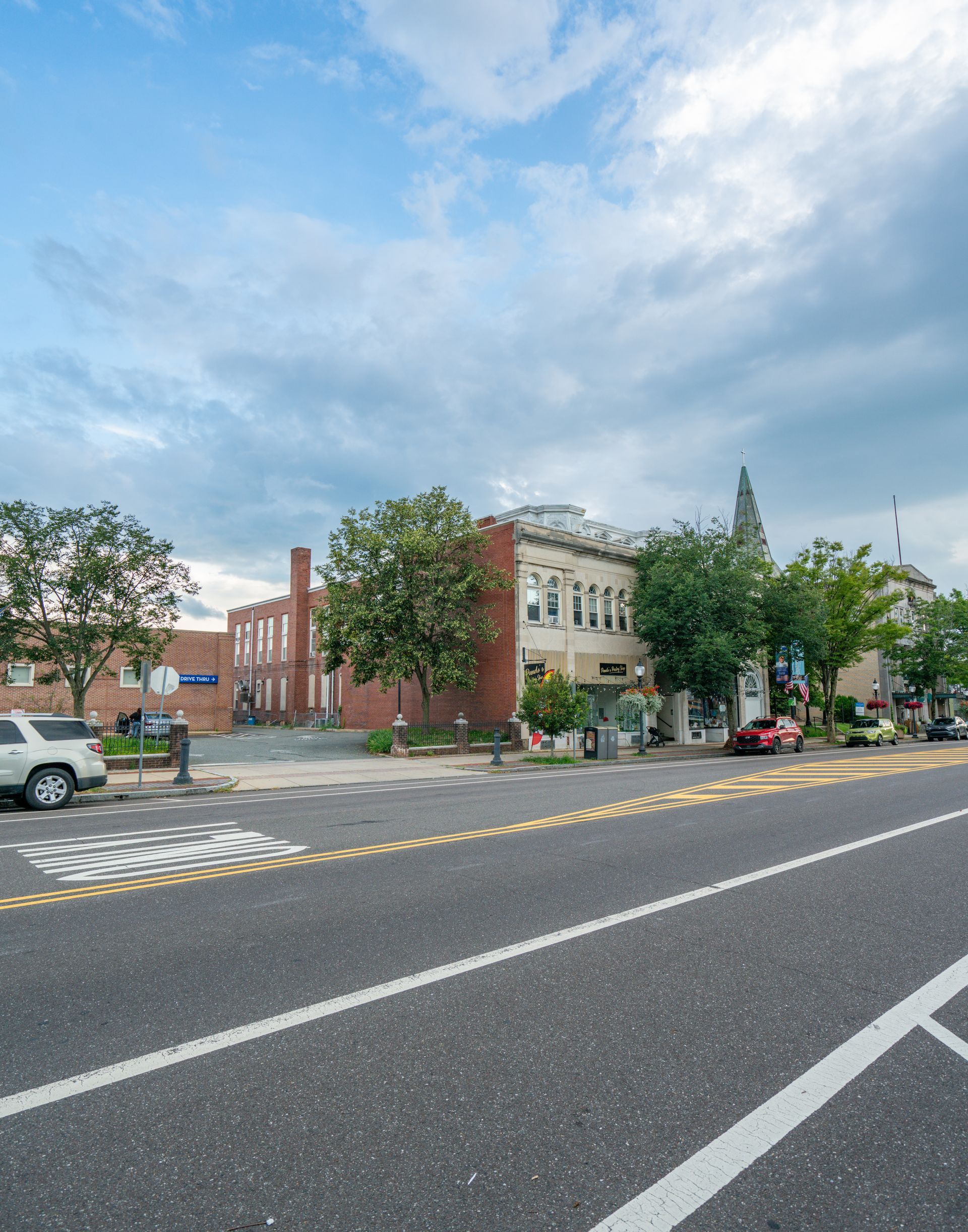 Photo of a mixed-use area, showing commercial and residential space, and a large building next to a parking lot