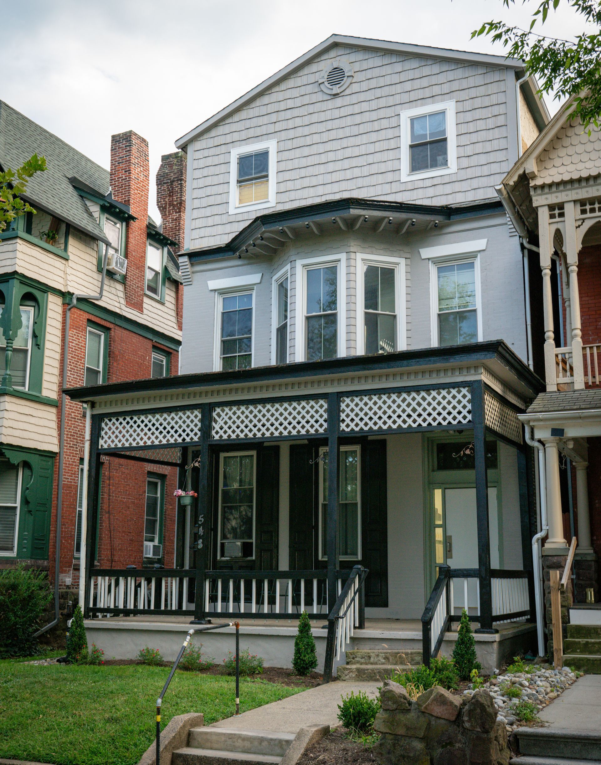 Photo of a 3 story building, seen from the right side of the front of the building, showing a 3/4 view