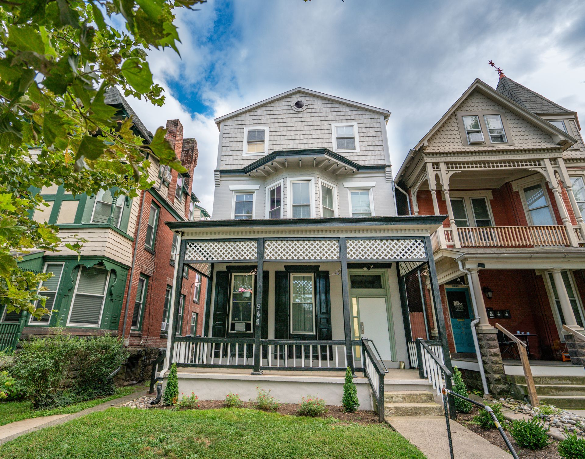 Photo of a 3 story building with a front balcony