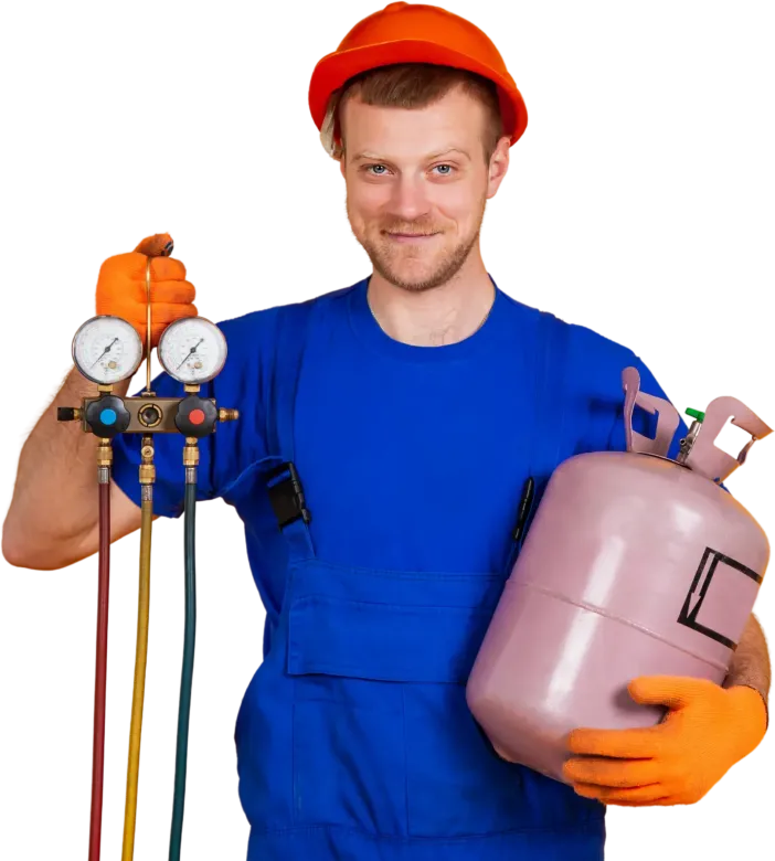 A man wearing a hard hat and safety vest is smiling with his arms crossed.