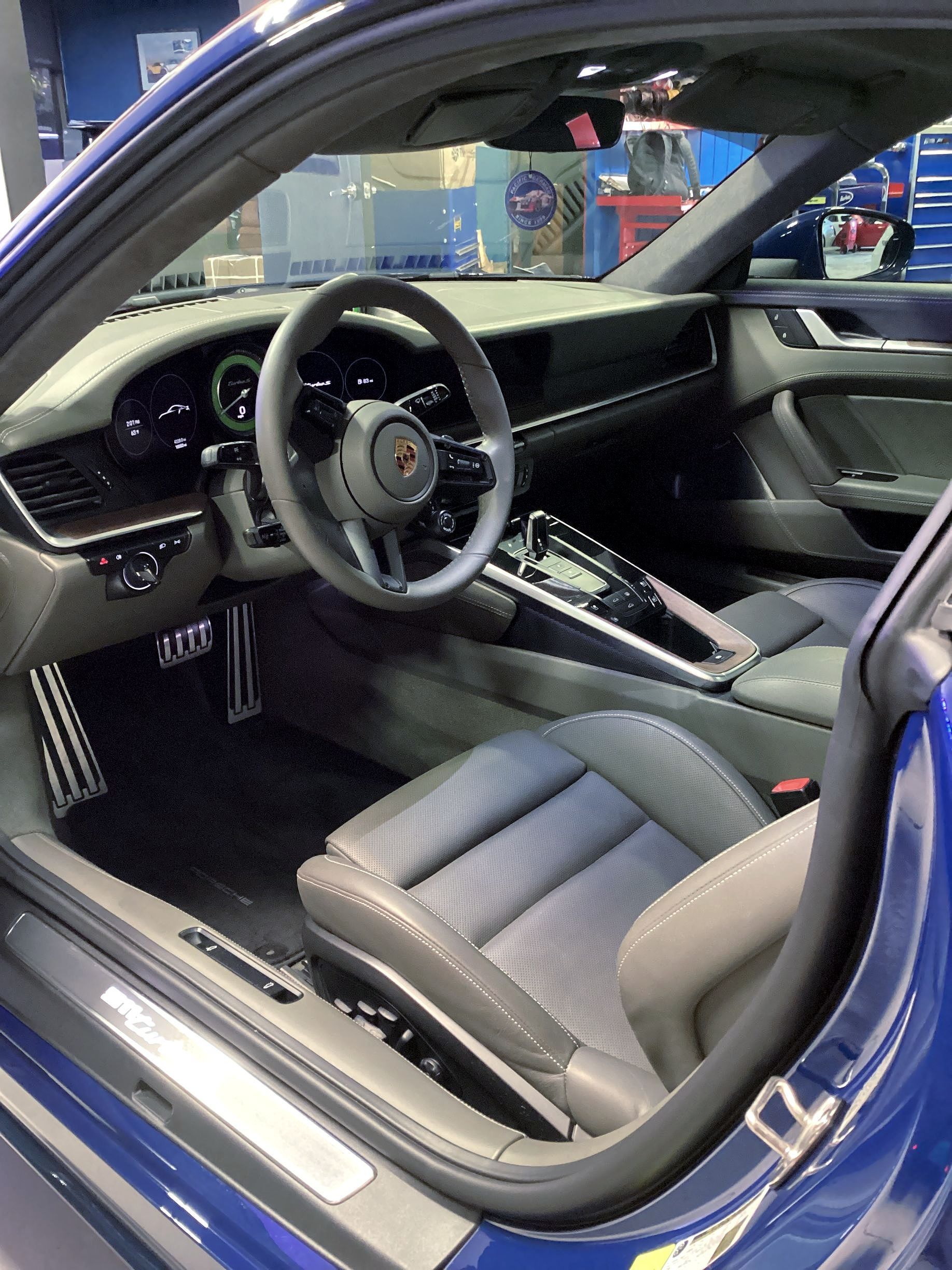 A clean, professionally detailed car interior featuring beige leather seats and a black dashboard.