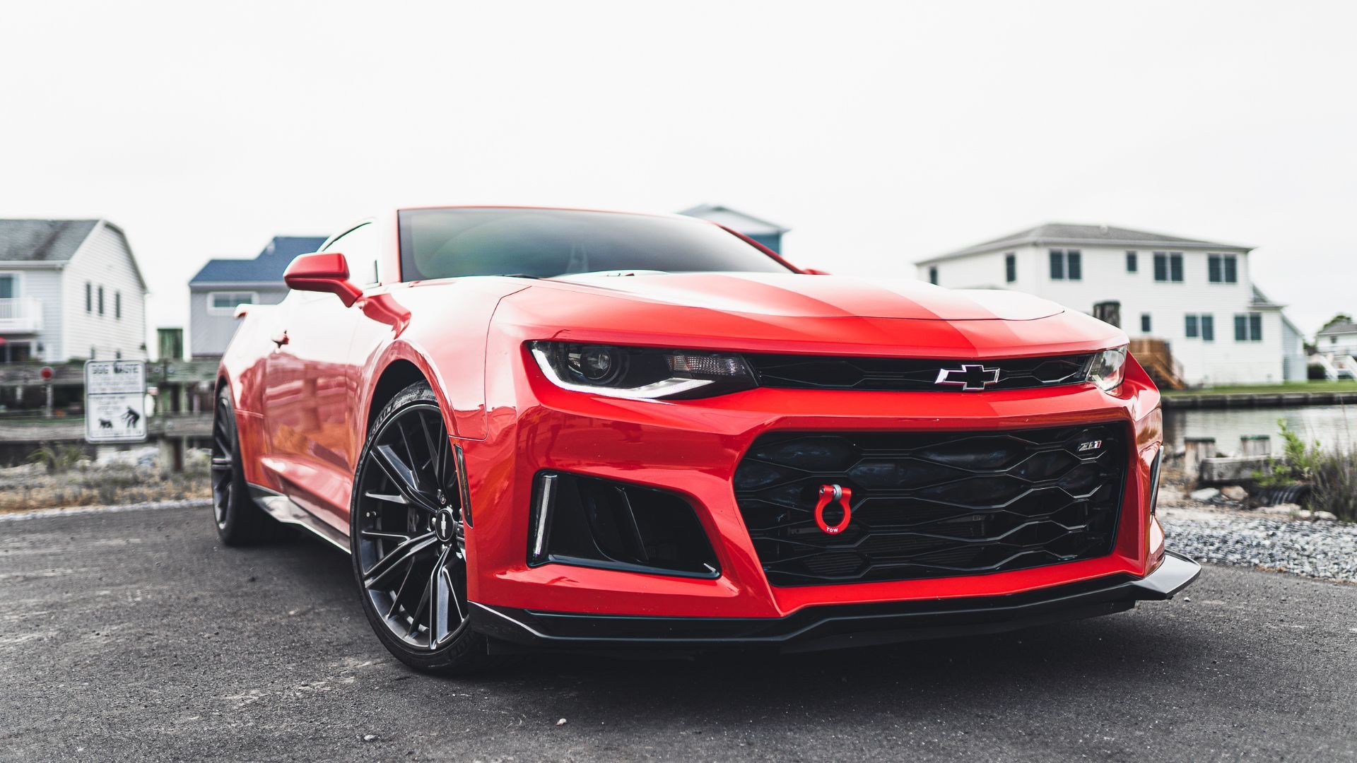 Blue Audi R8 sports car with gold rims parked on a street.