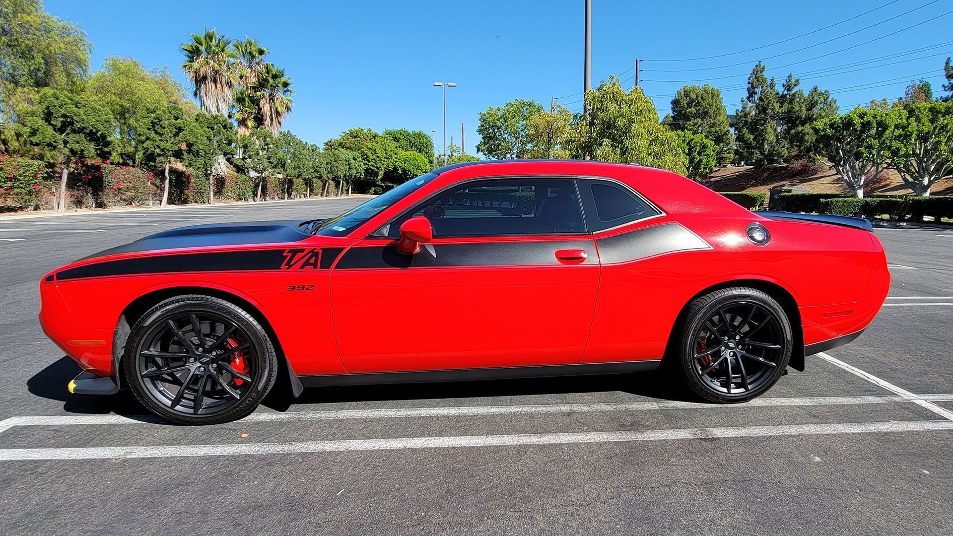 Blue Audi R8 sports car with gold rims parked on a street.