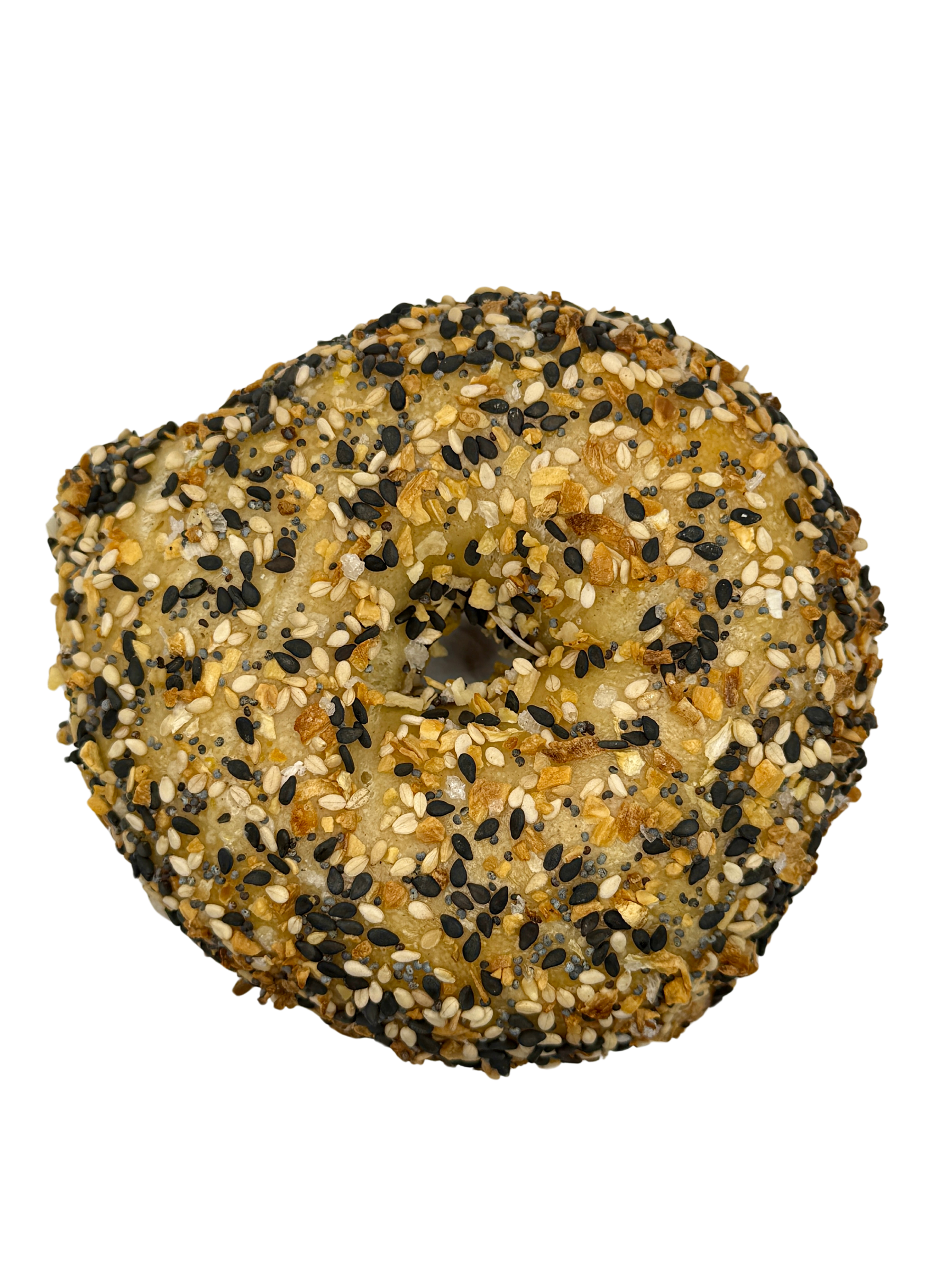 A close up of a bagel with everything seasoning on a white background