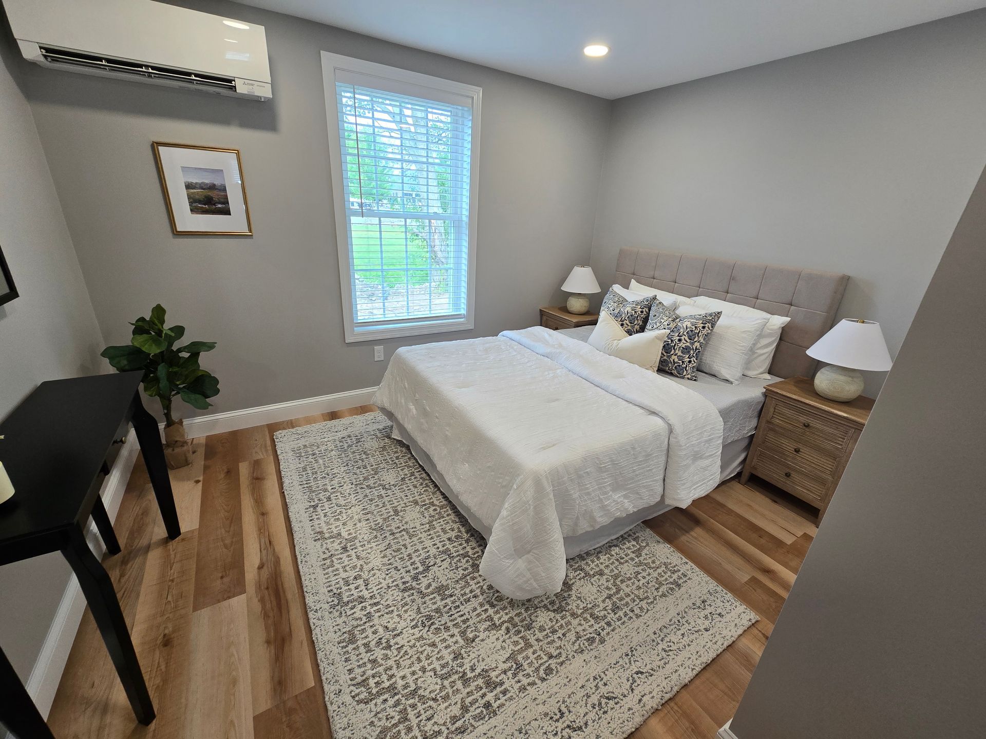 Interior photo of 371 Elm St bedroom with a bed , nightstand , rug and window.
