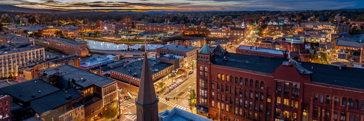 An aerial view of a city at night with a church in the middle of the city.