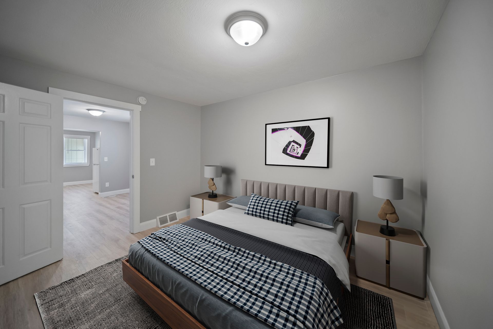 Interior photo of 58 Perham St bedroom with a large bed , nightstands , lamps and a rug.