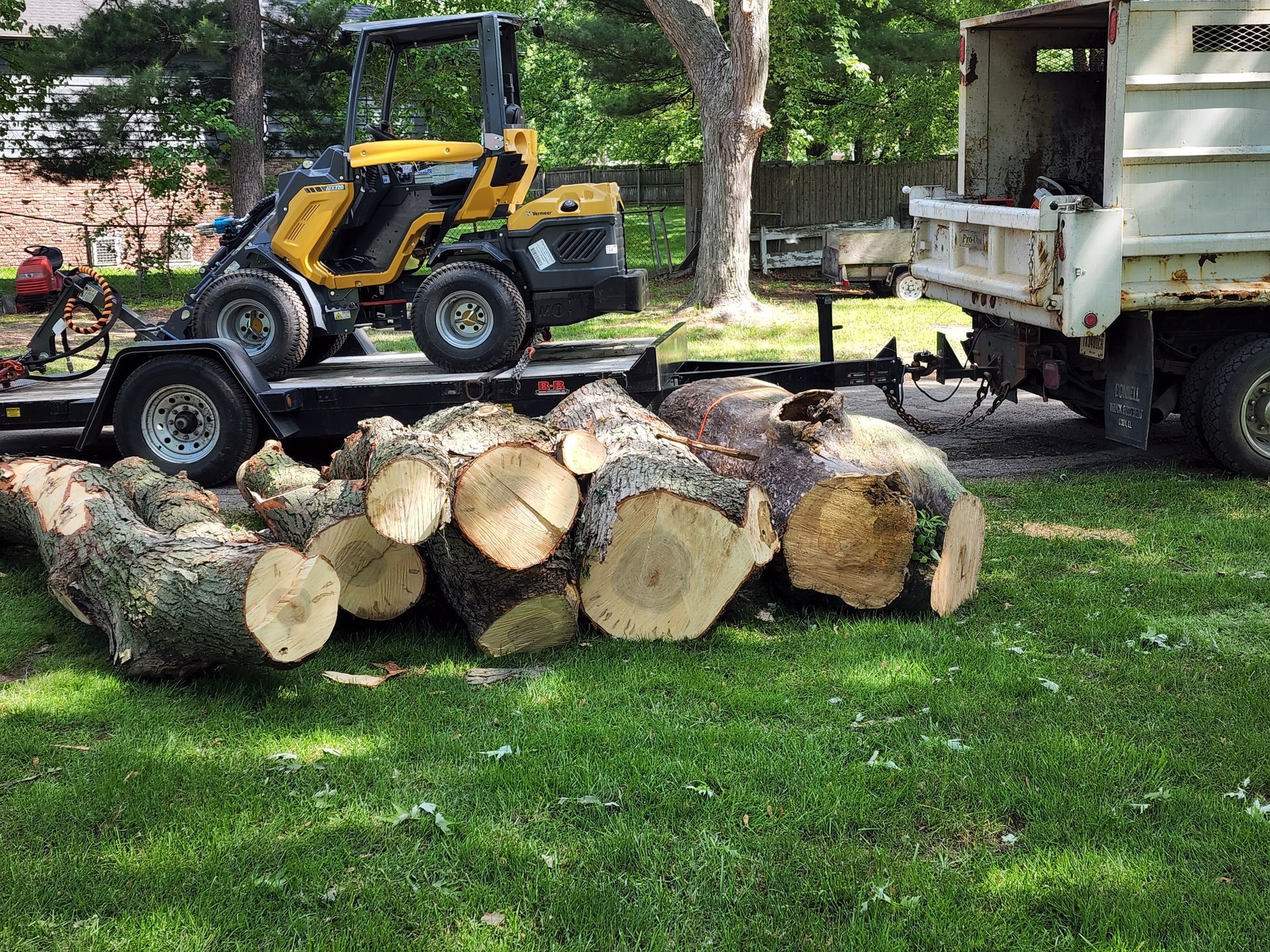A tractor is pulling a trailer full of logs.