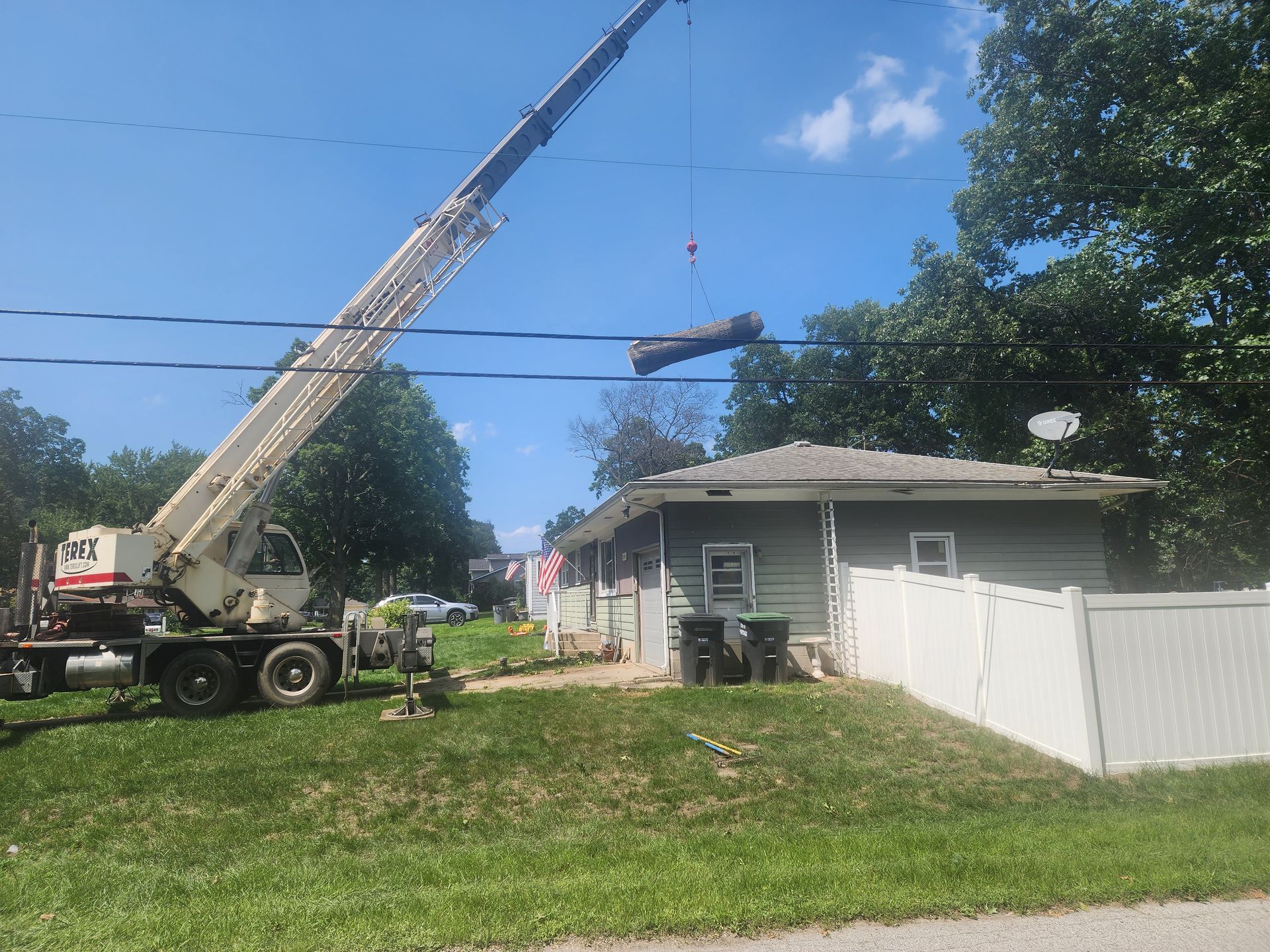 A crane is lifting a roof over a house in Portage, IN