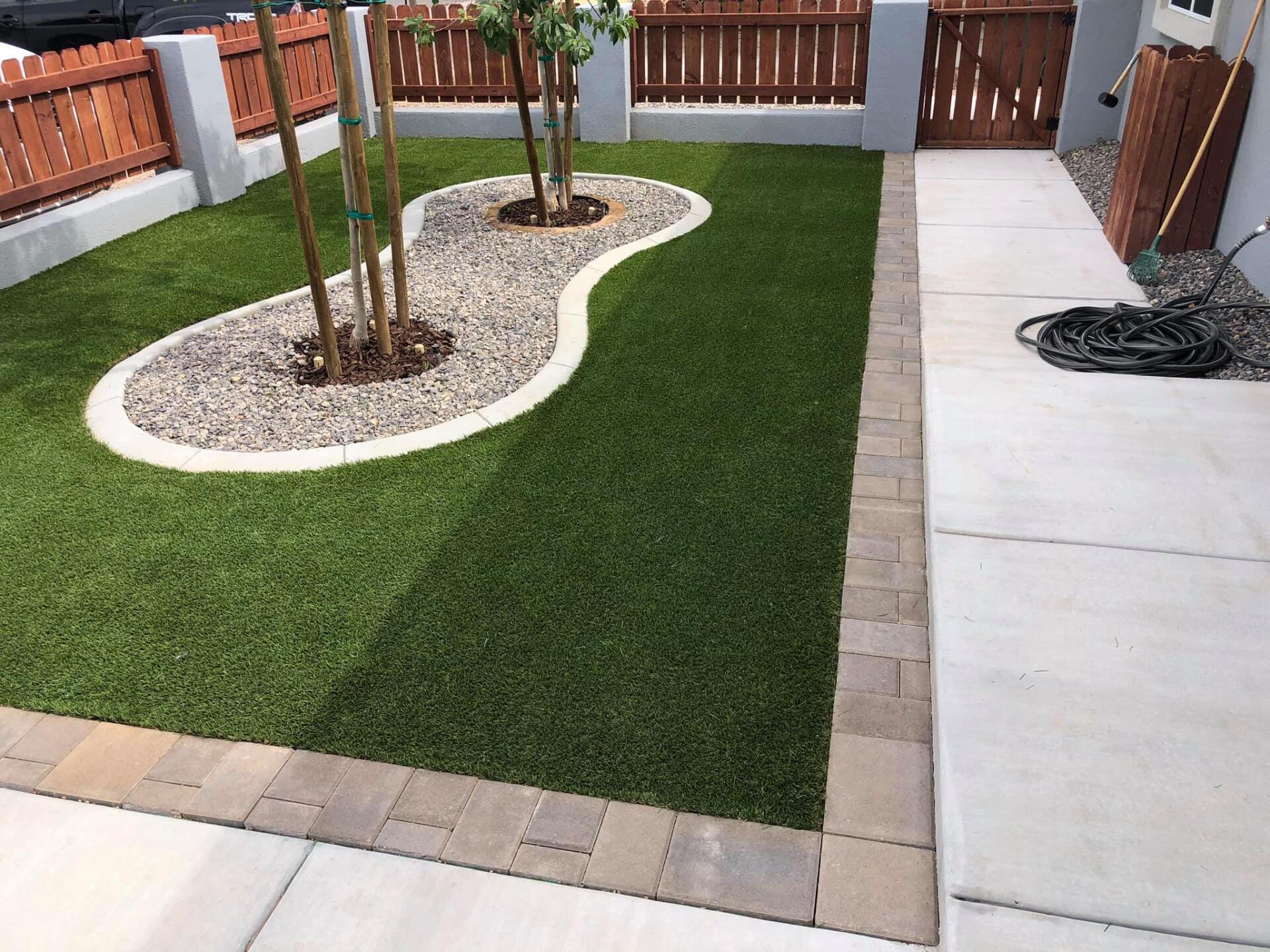 A lawn with a tree in the middle of it