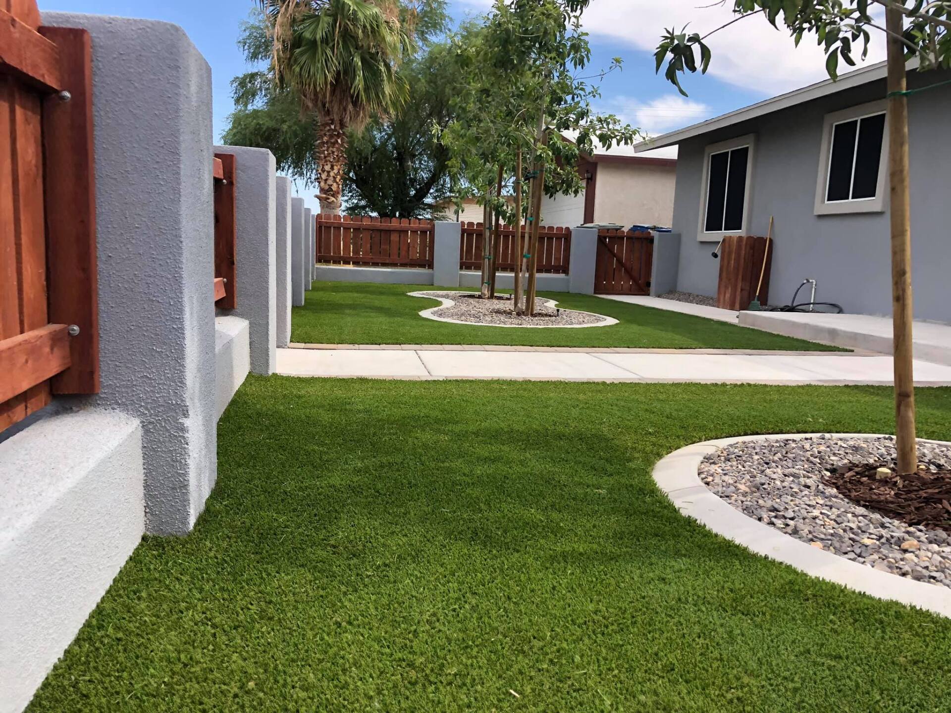 A house with a fence and a lush green lawn
