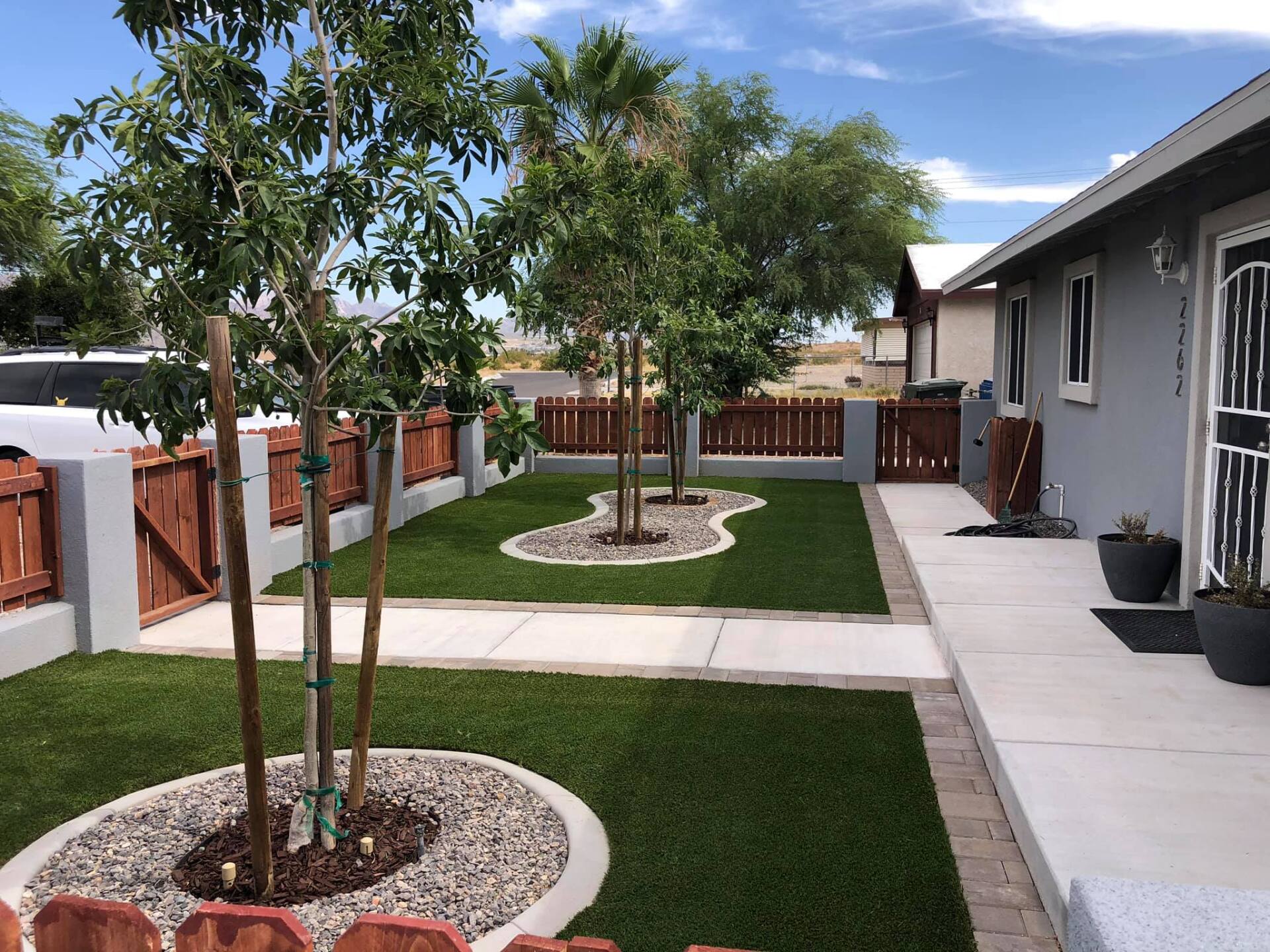 A house with a lawn and trees in front of it