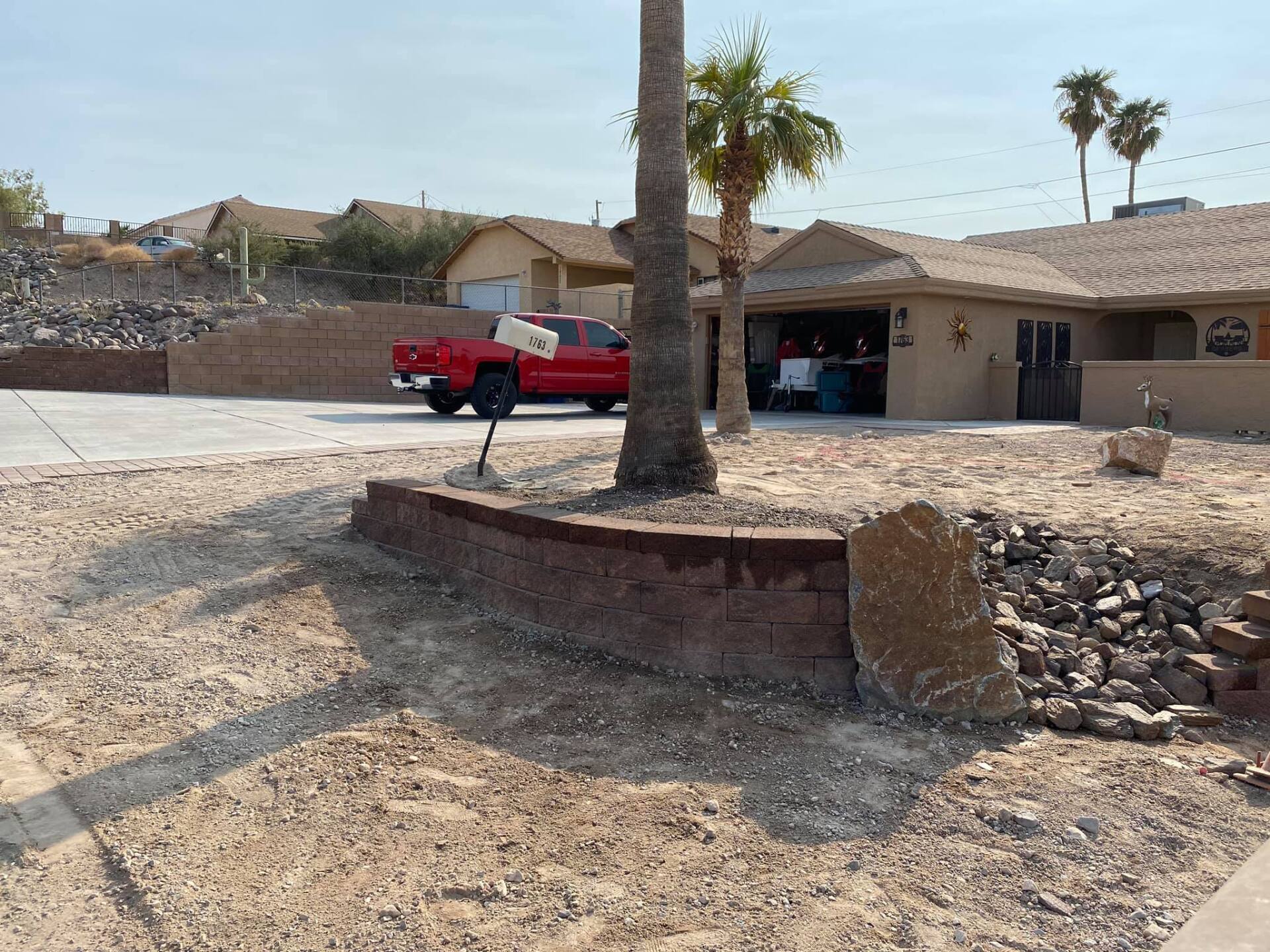 A red truck is parked in front of a house.