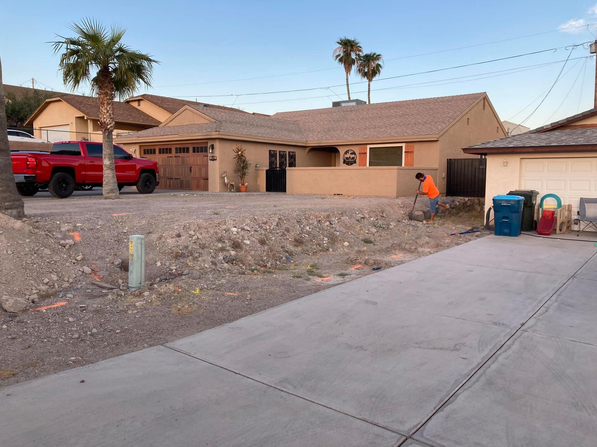 A red truck is parked in front of a house