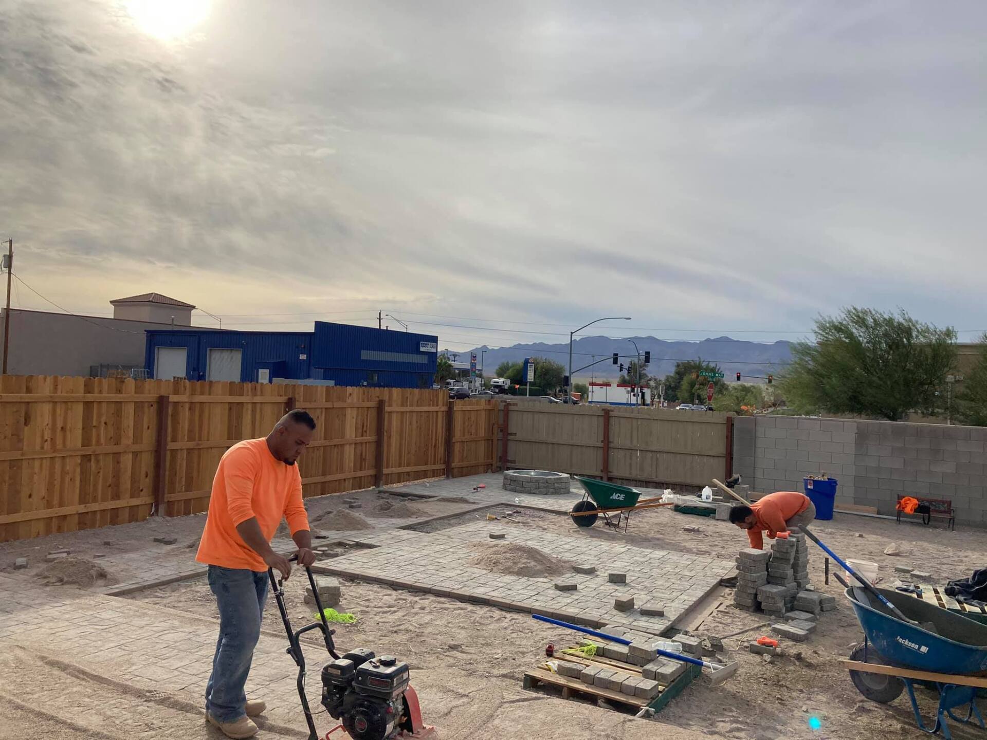 A man is working on a construction site with a vacuum cleaner.