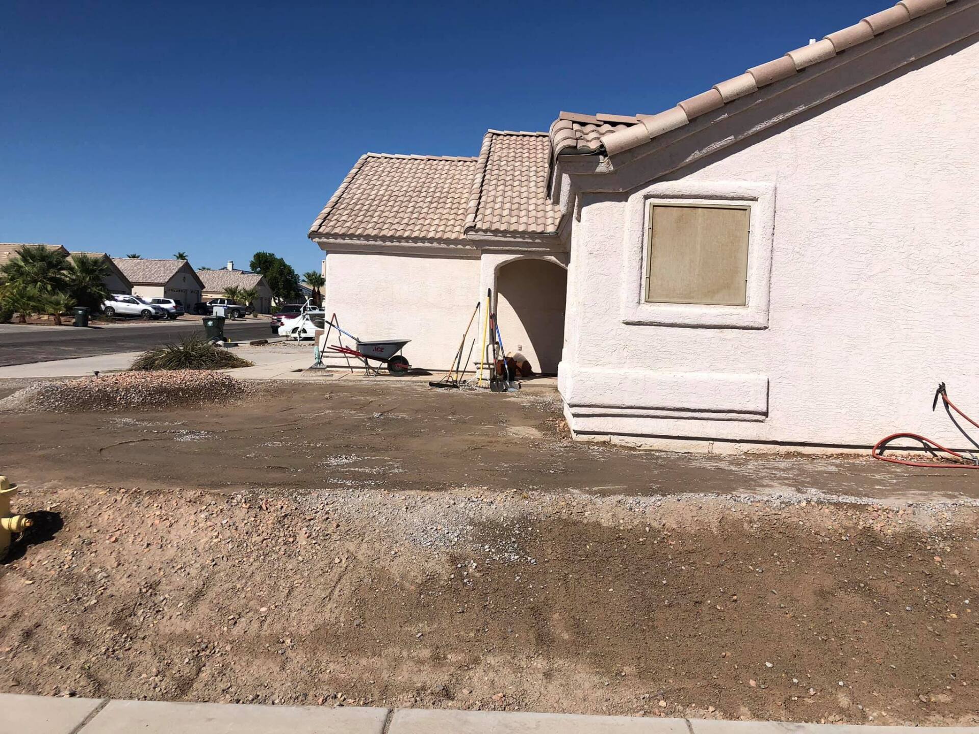 A house that is being remodeled with a wheelbarrow in front of it