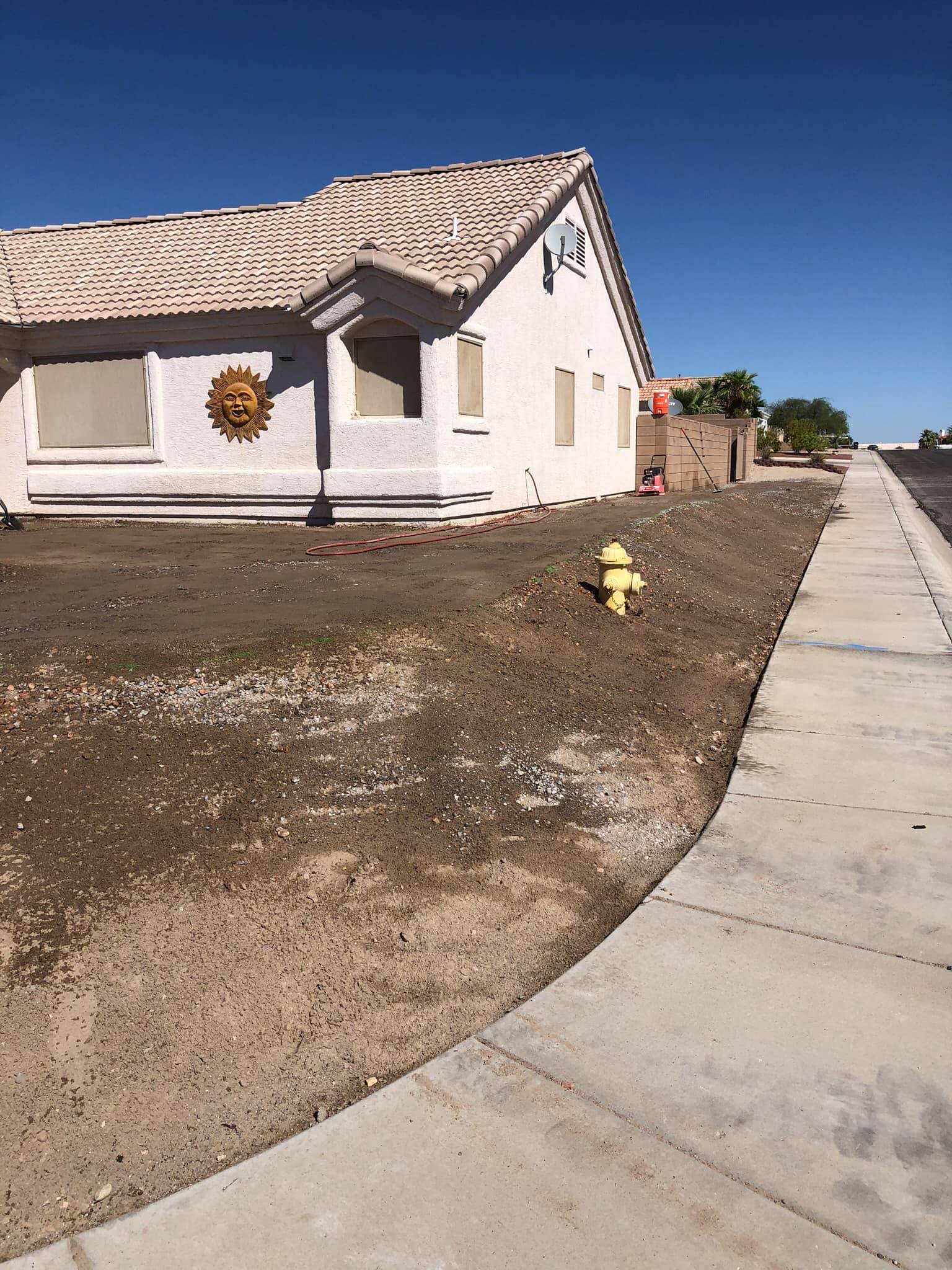 A white house with a yellow fire hydrant in front of it.