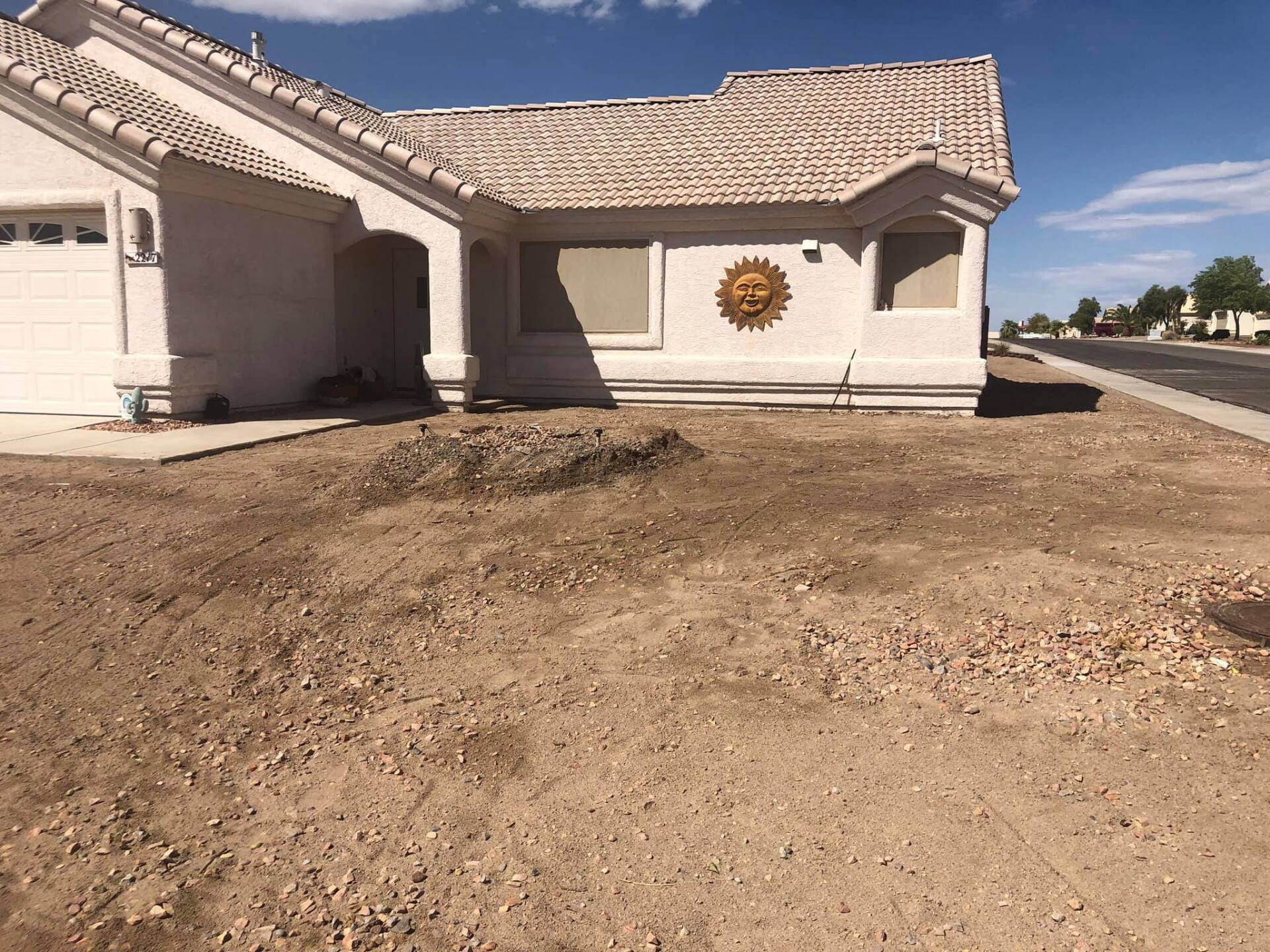 A white house with a sun on the side of it