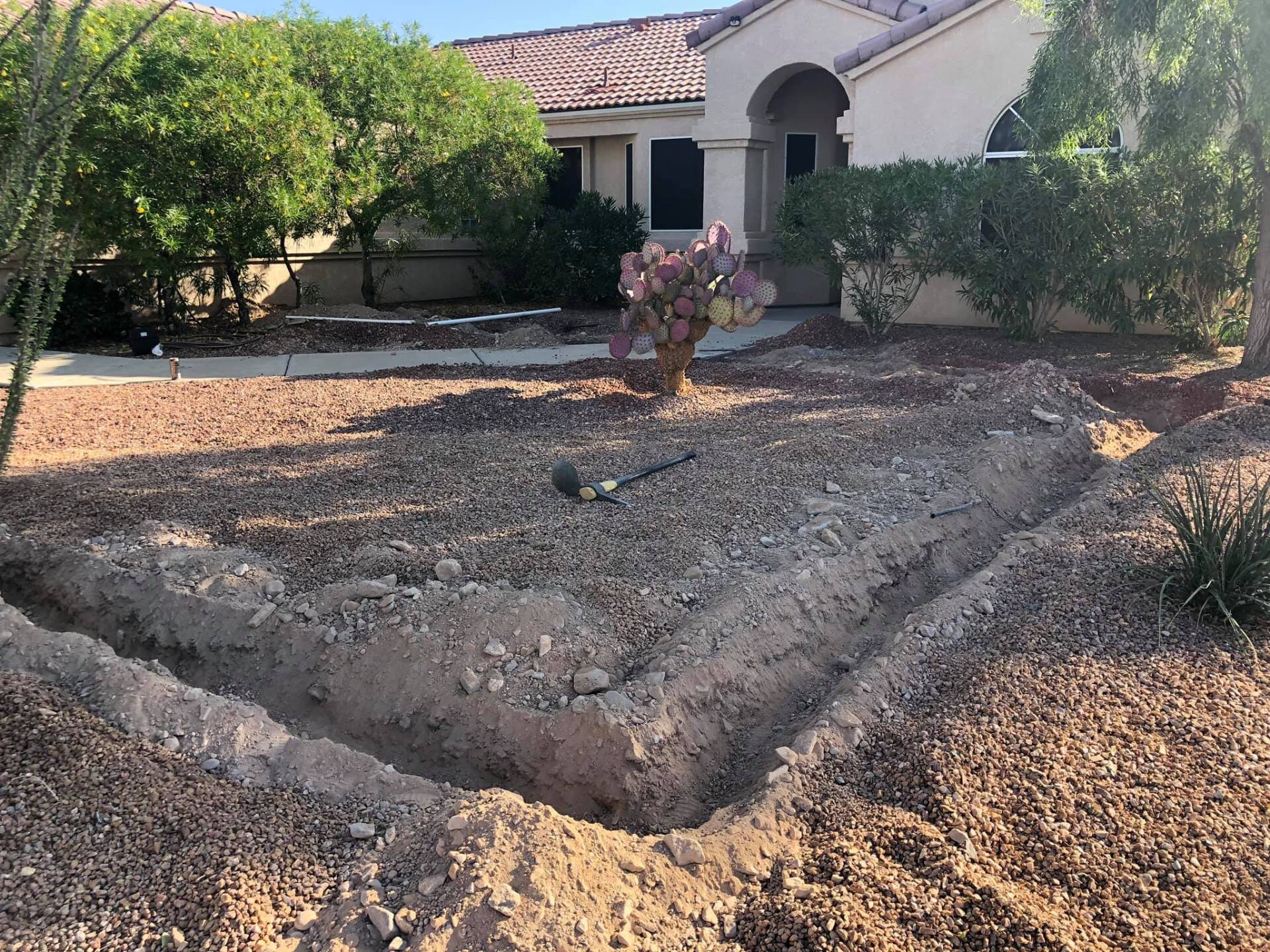 A large pile of dirt is in front of a house.