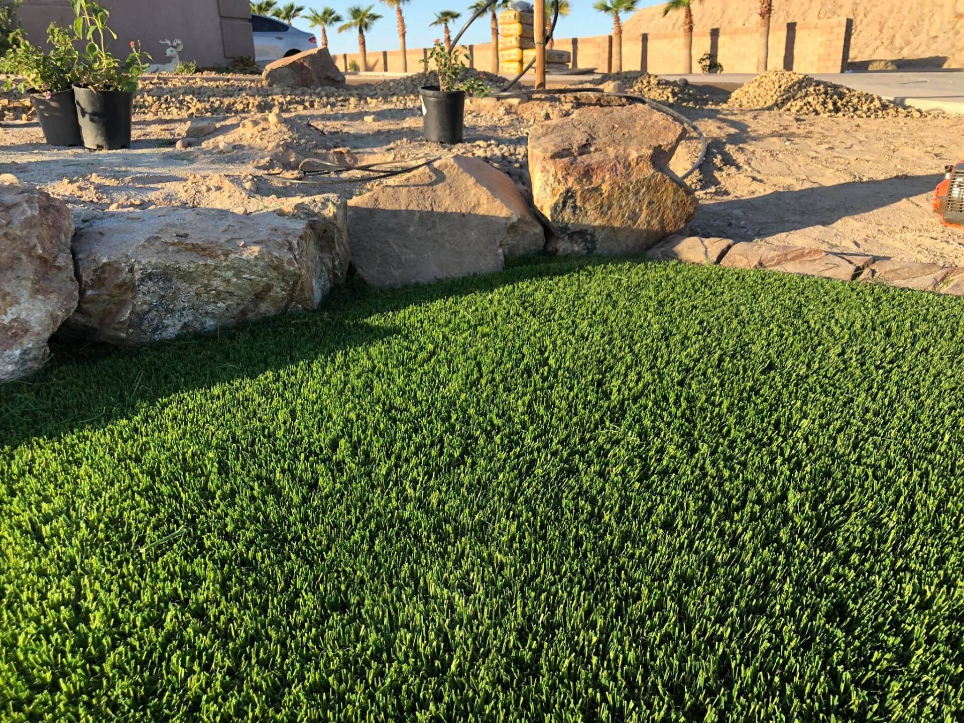 A lawn with a lot of green grass and rocks