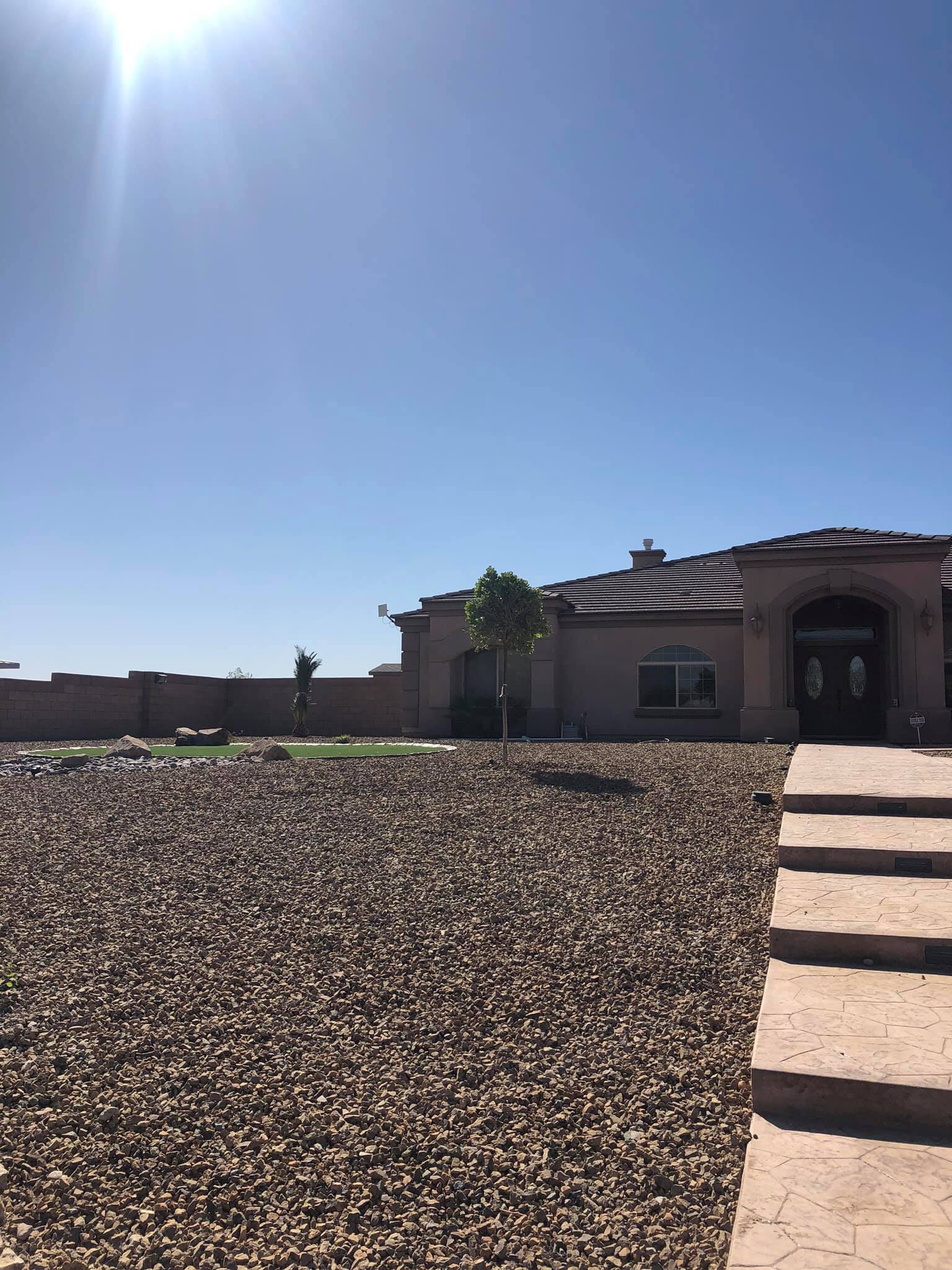 A house with a lot of gravel in front of it