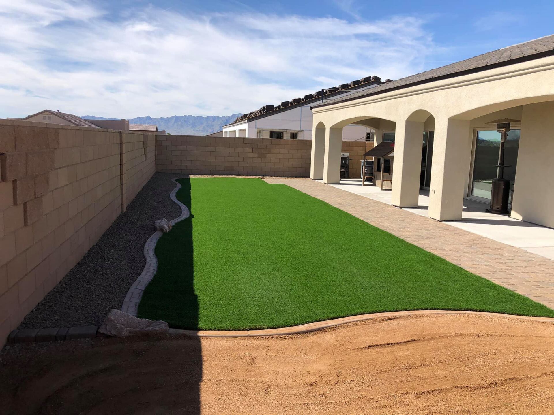 A house with a large lawn in front of it.
