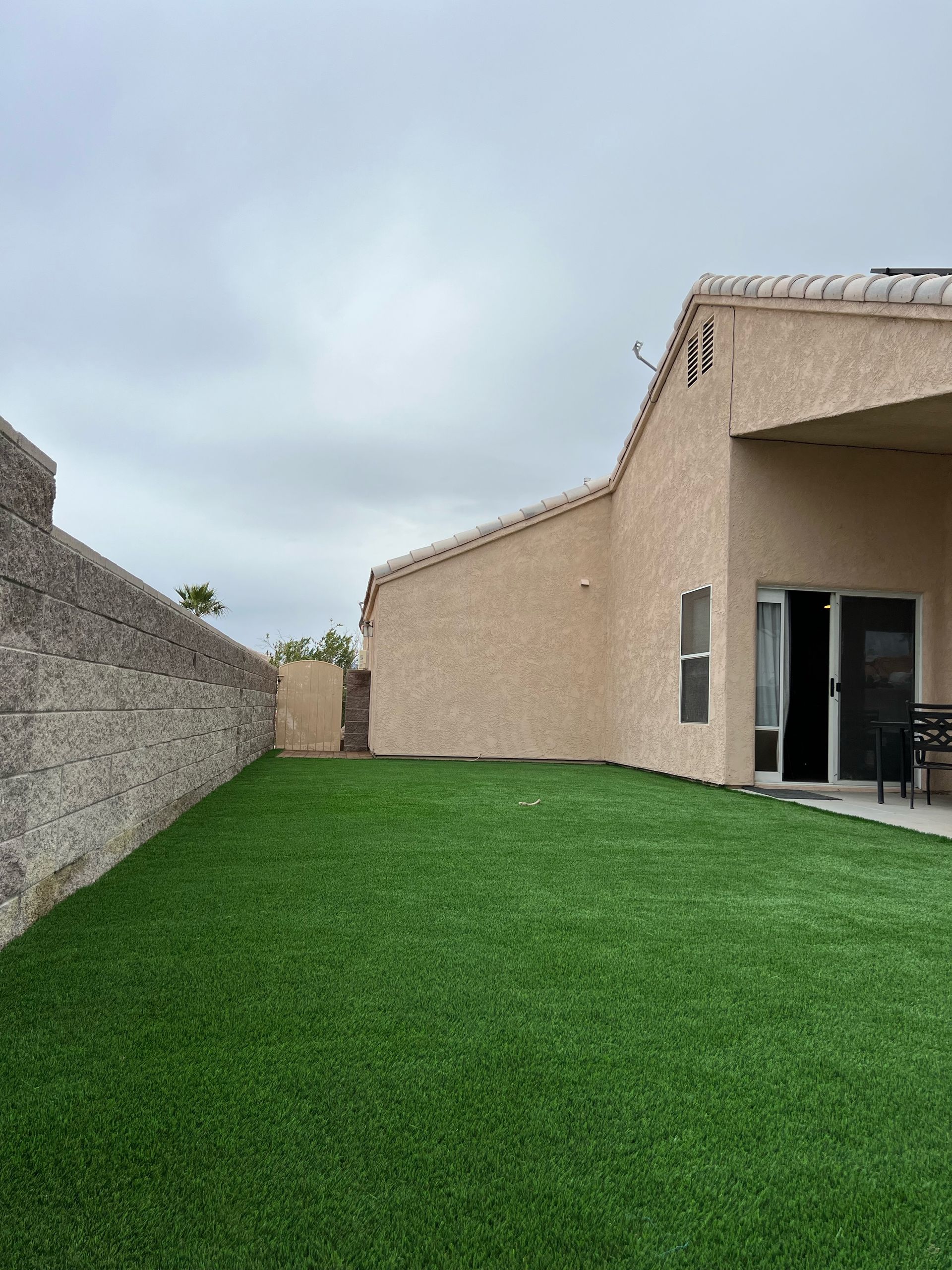 A house with a large lawn in front of it.