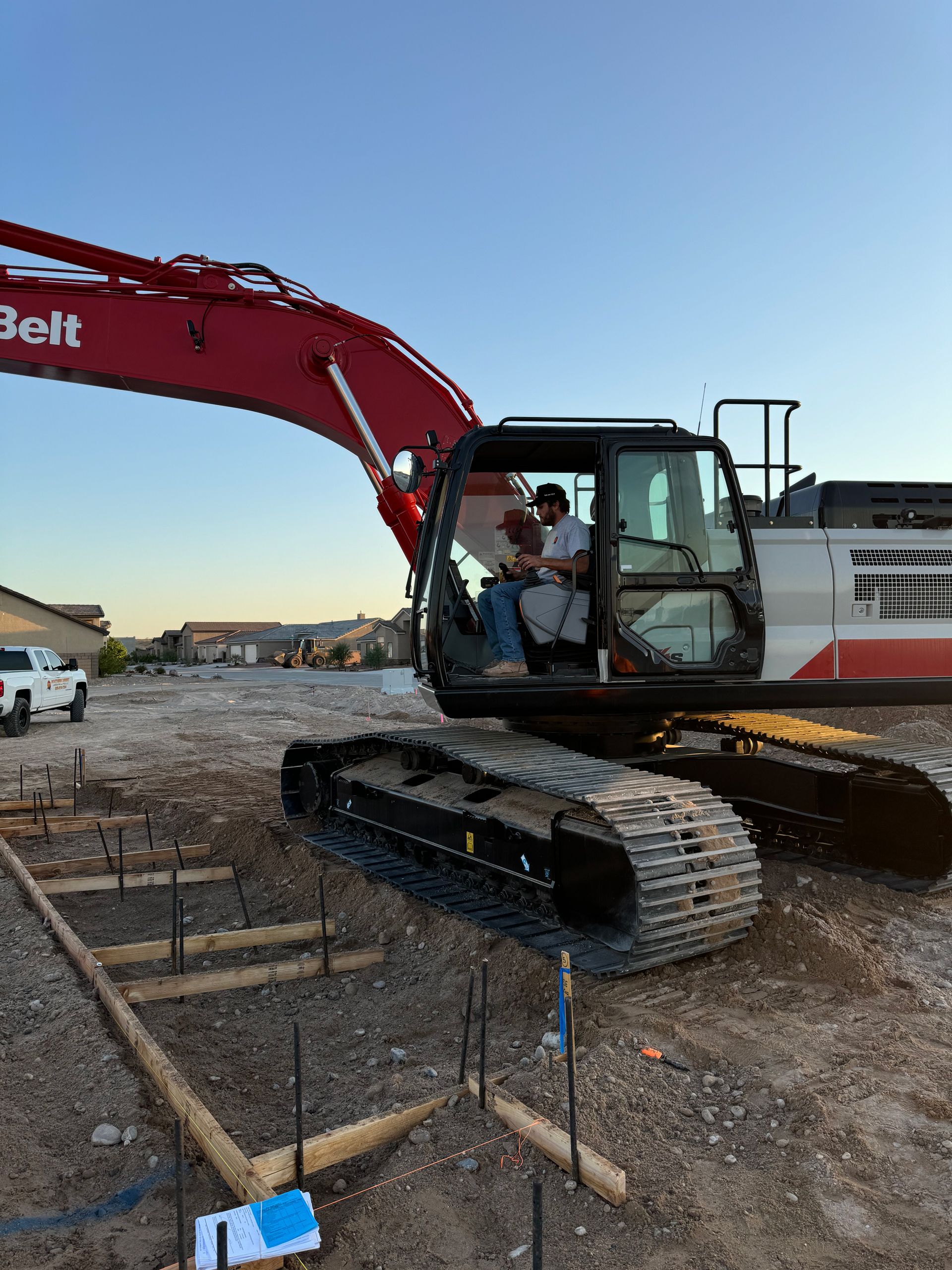 A man is sitting in the driver 's seat of a belt excavator.