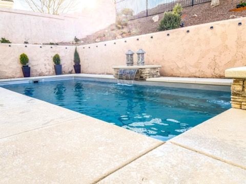 A large swimming pool with a bench in the middle of it